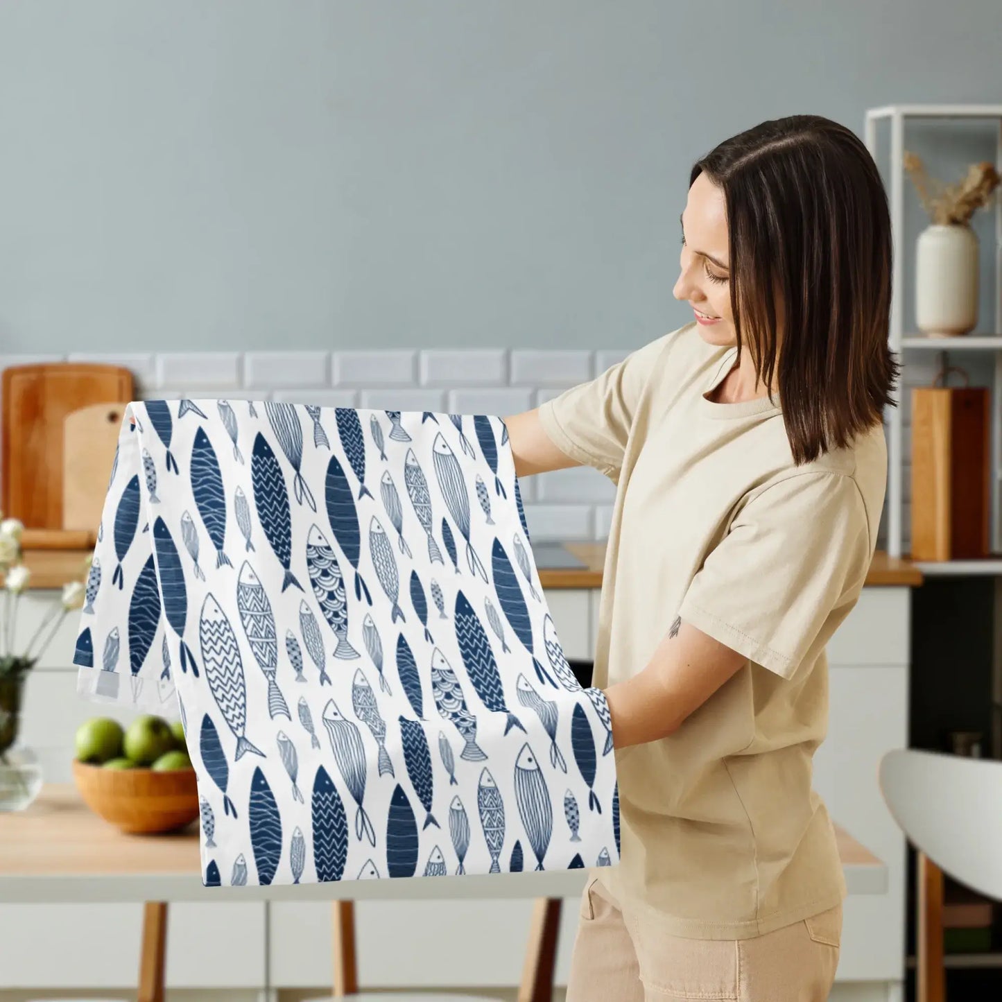 Blue Fish Coastal Table Runner – Nautical Dining Decor displayed by a woman in a kitchen setting.