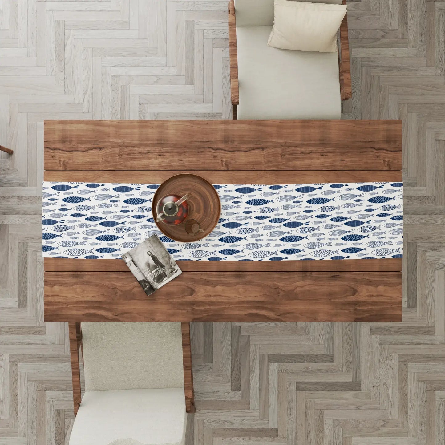 Blue Fish Coastal Table Runner – Nautical Dining Decor on a wooden table with chairs, showcasing a coastal design.
