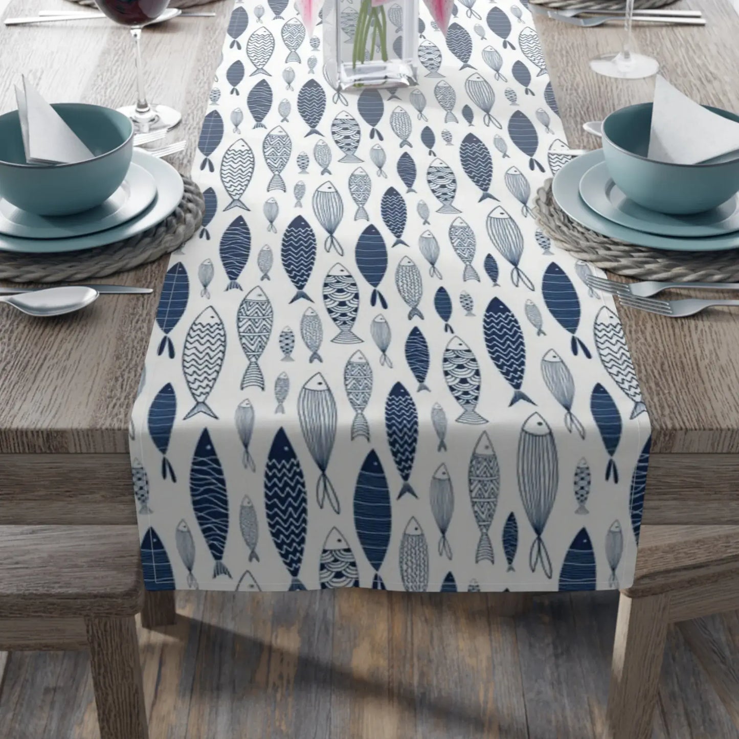 Blue Fish Coastal Table Runner – Nautical Dining Decor with a hand-illustrated fish pattern on a dining table.