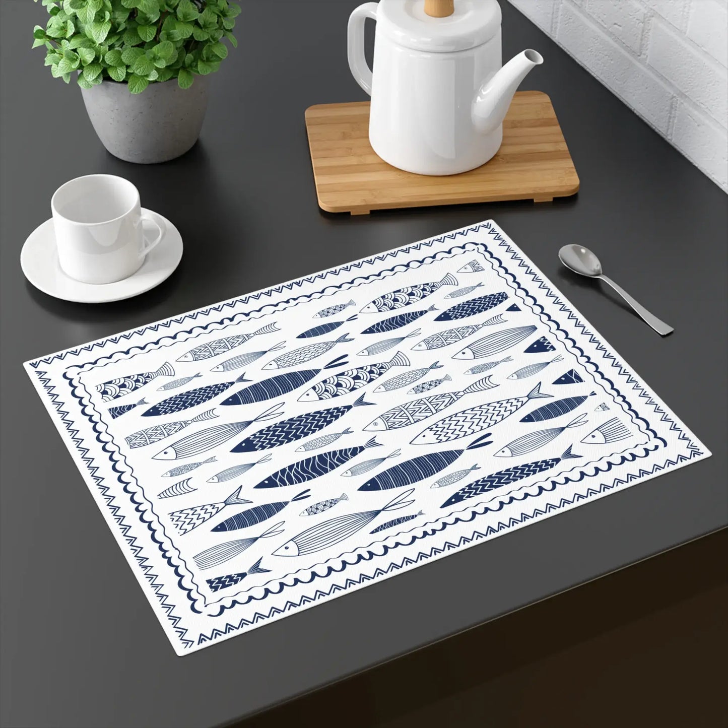 Blue Fish Cotton Placemats featuring hand-drawn navy blue fish illustrations on a table.