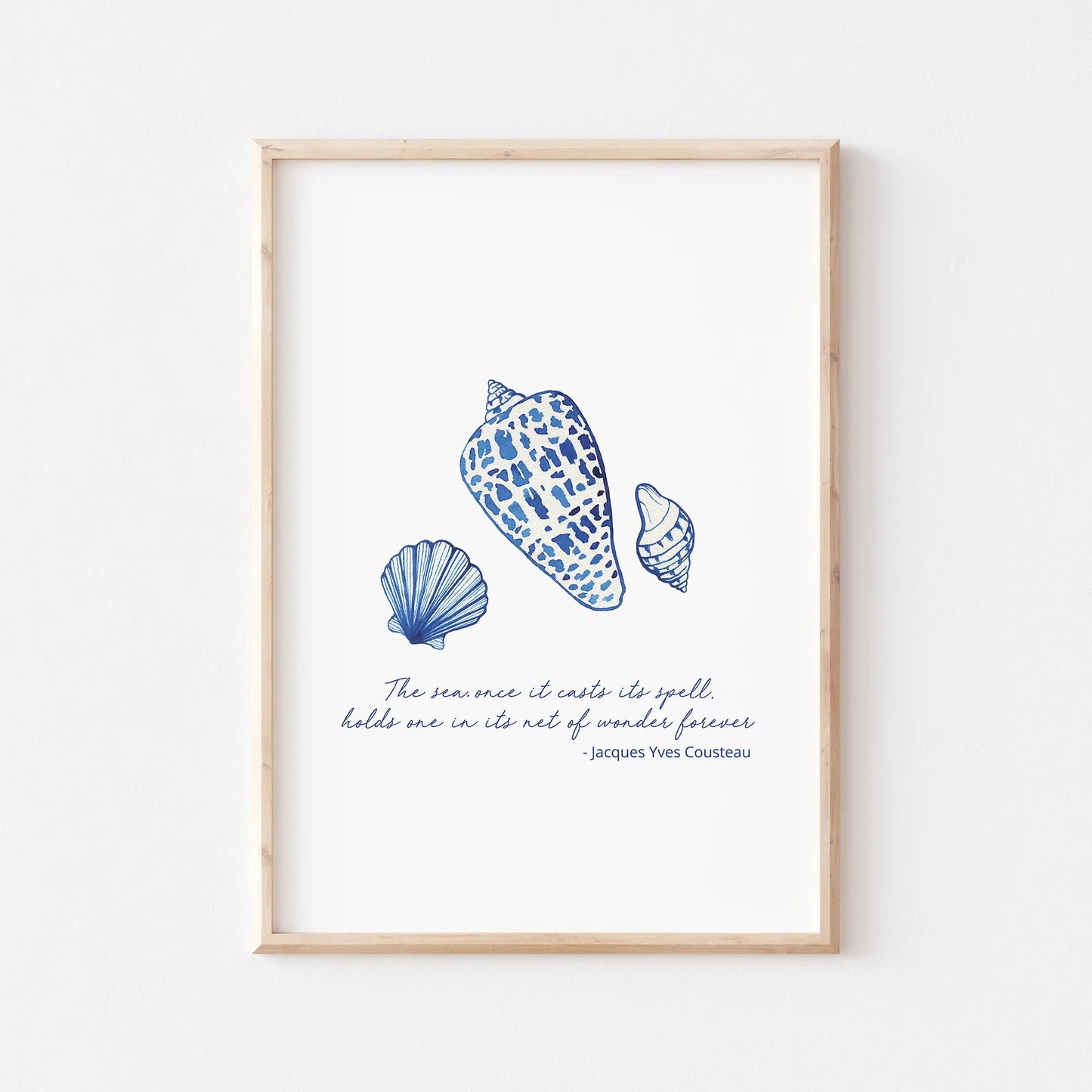 Coastal prints featuring detailed blue seashell illustrations and a quote by Jacques Yves Cousteau for beach-themed decor.