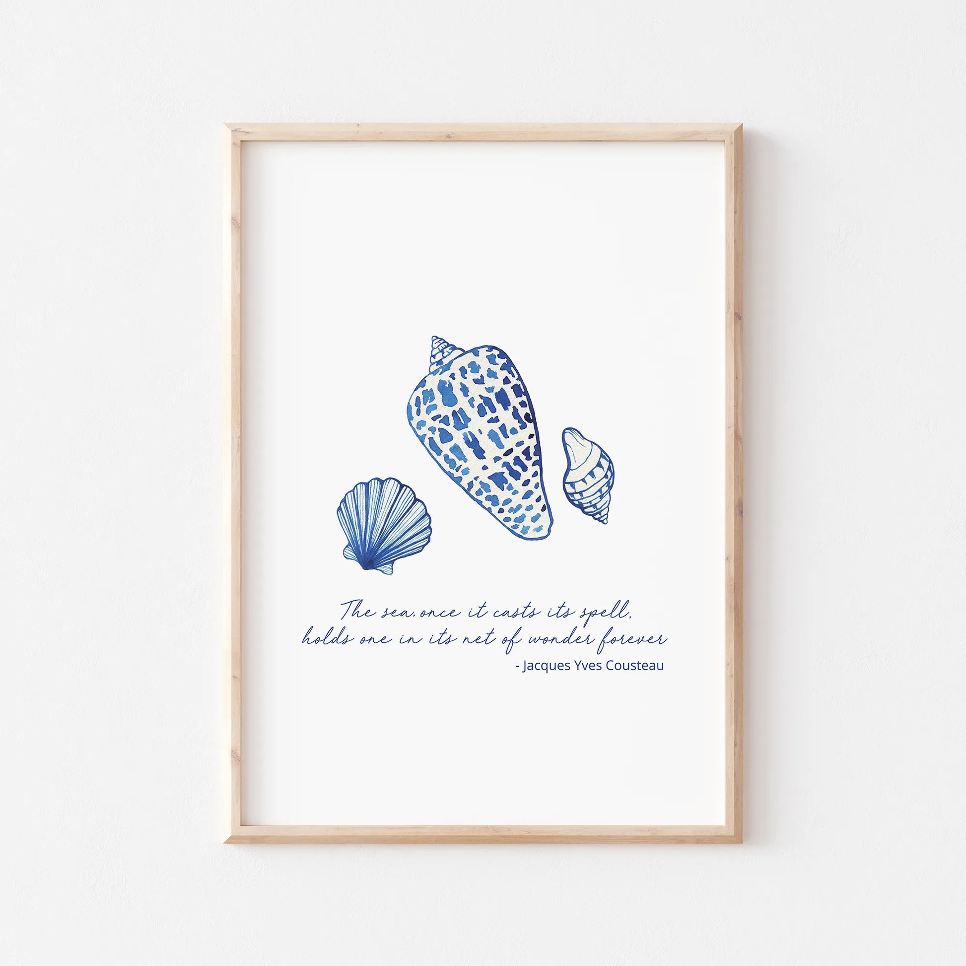 Coastal prints featuring detailed blue seashell illustrations and a quote by Jacques Yves Cousteau for beach-themed decor.
