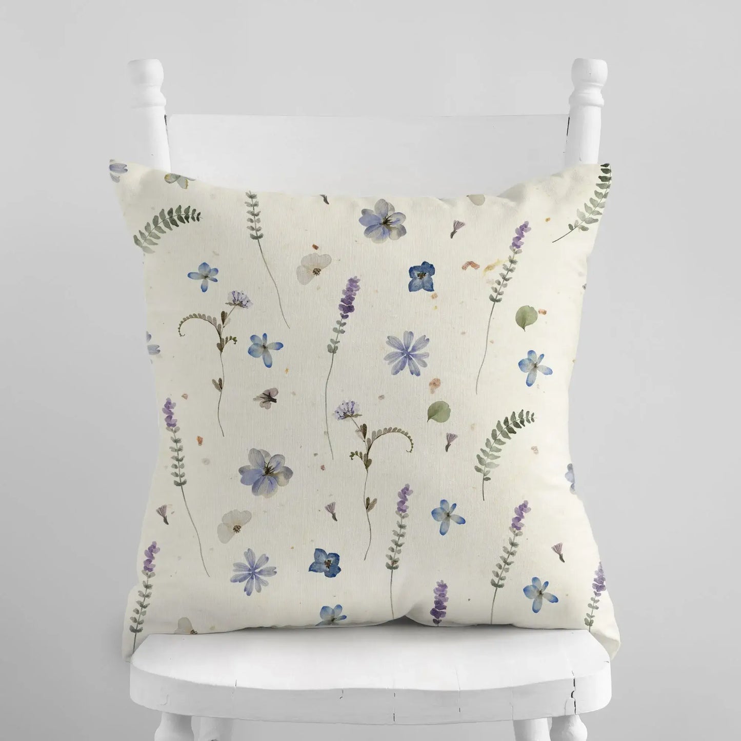 Botanical pattern pillow displayed on a chair, nature-inspired decor.