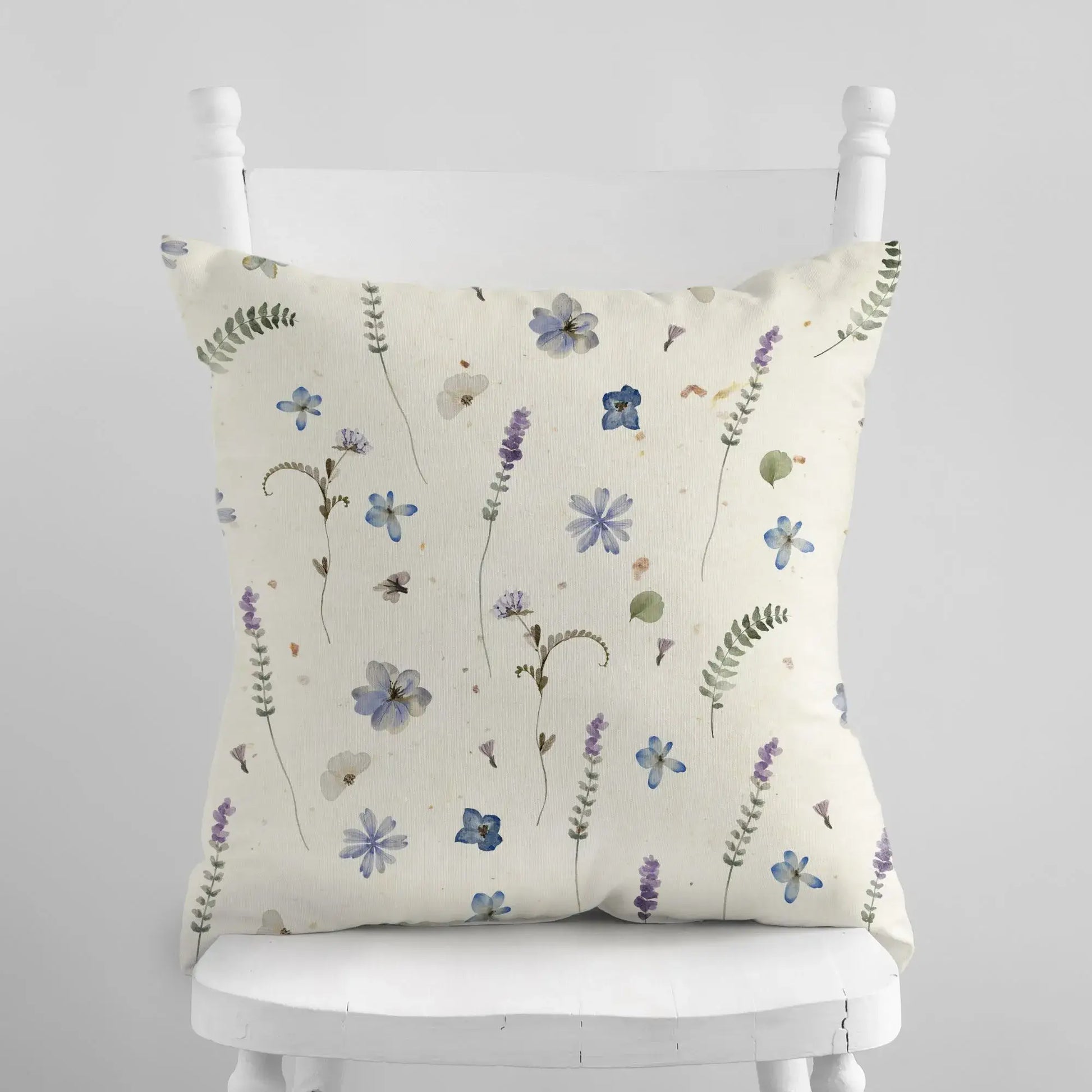 Botanical pattern pillow displayed on a chair, nature-inspired decor.