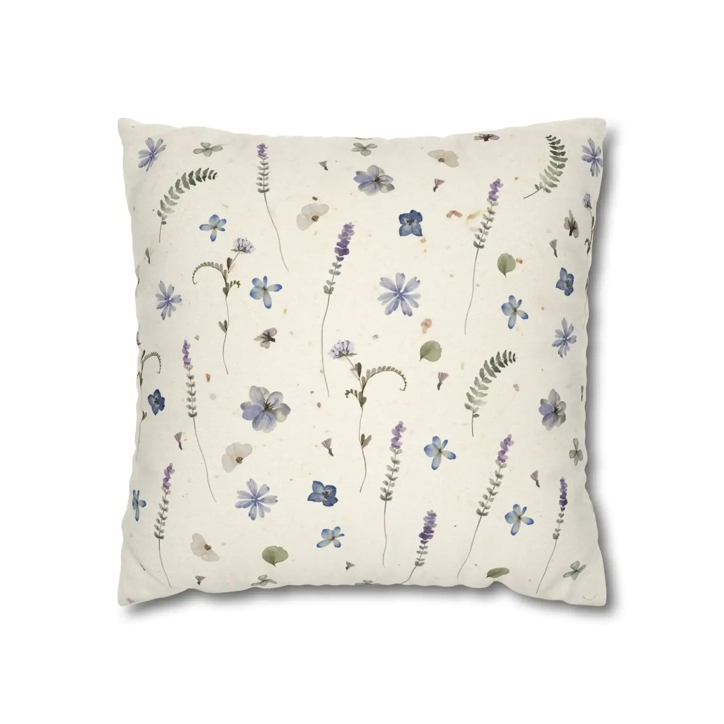 Cream pillow with blue and purple floral pattern. Botanical home decor.