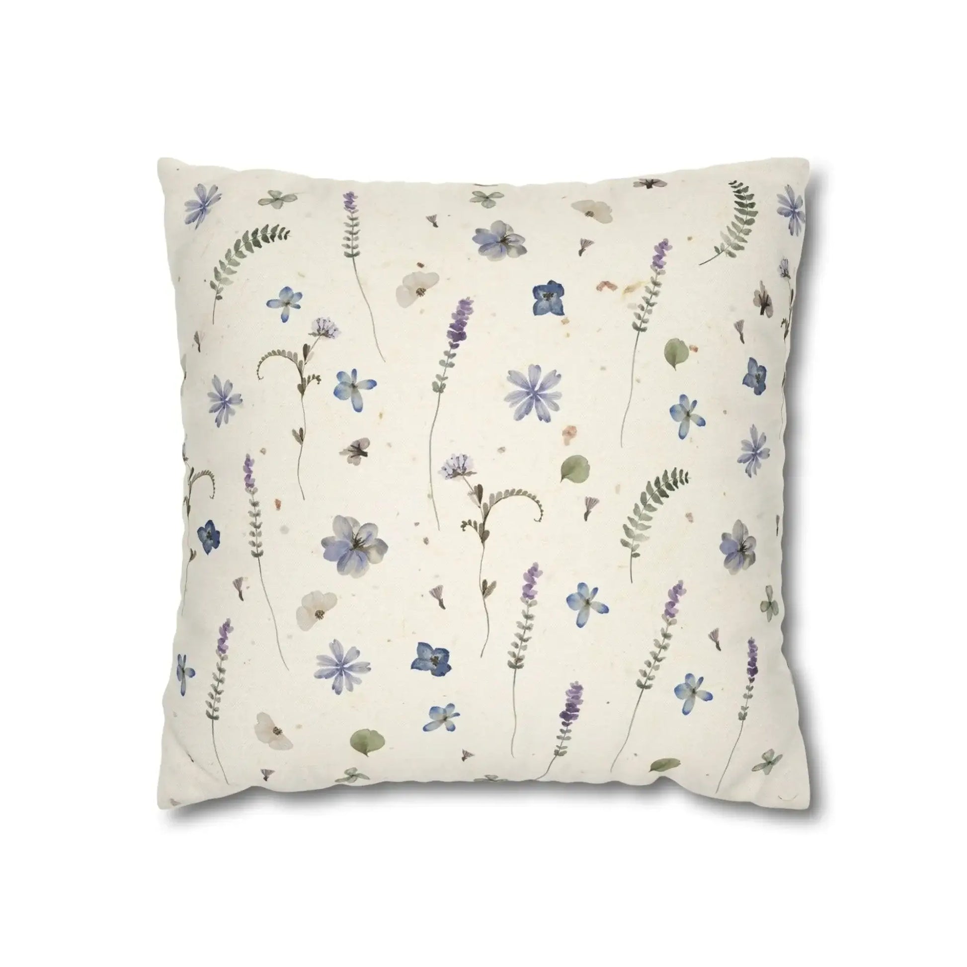 Cream pillow with blue and purple floral pattern. Botanical home decor.