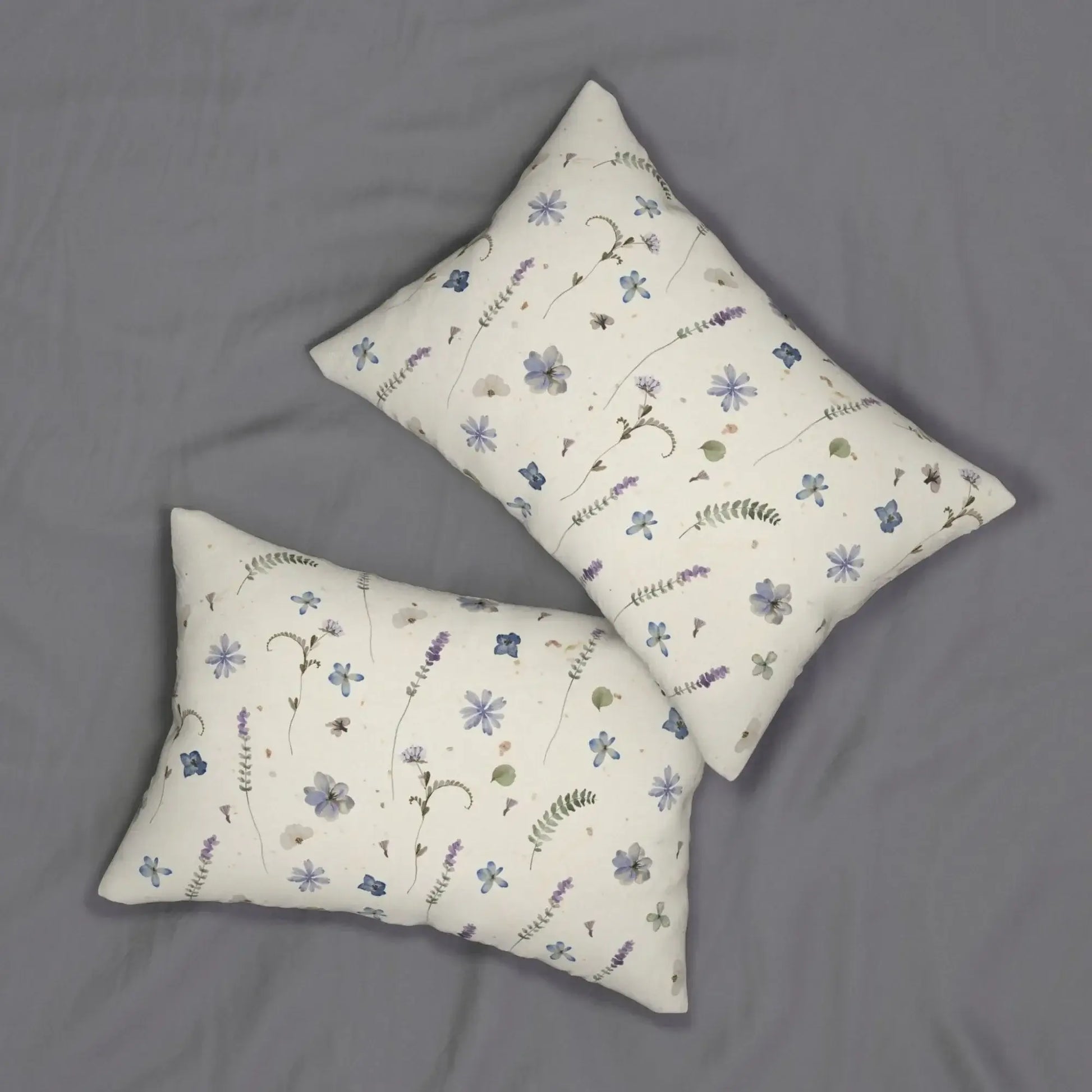 Two floral lumbar pillows on gray fabric
