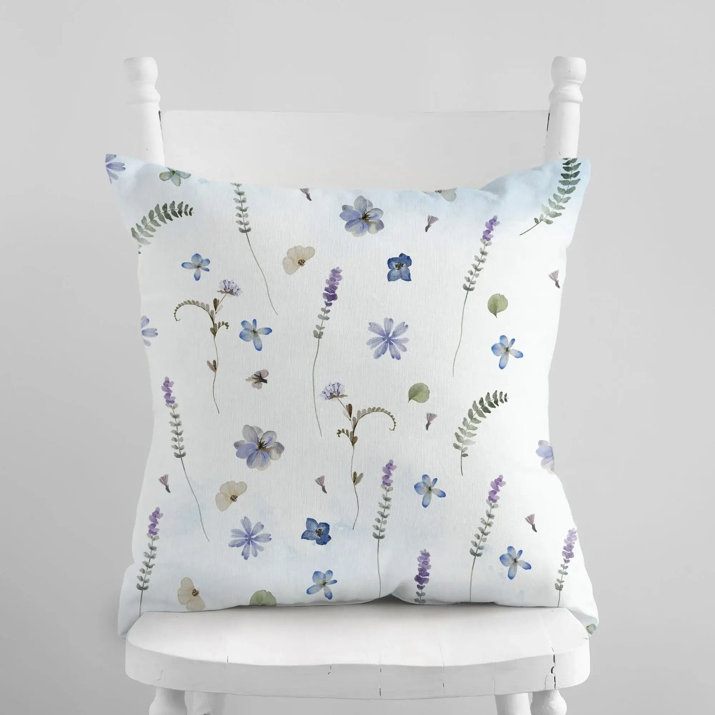 Floral design pillow displayed on a chair, home accent.