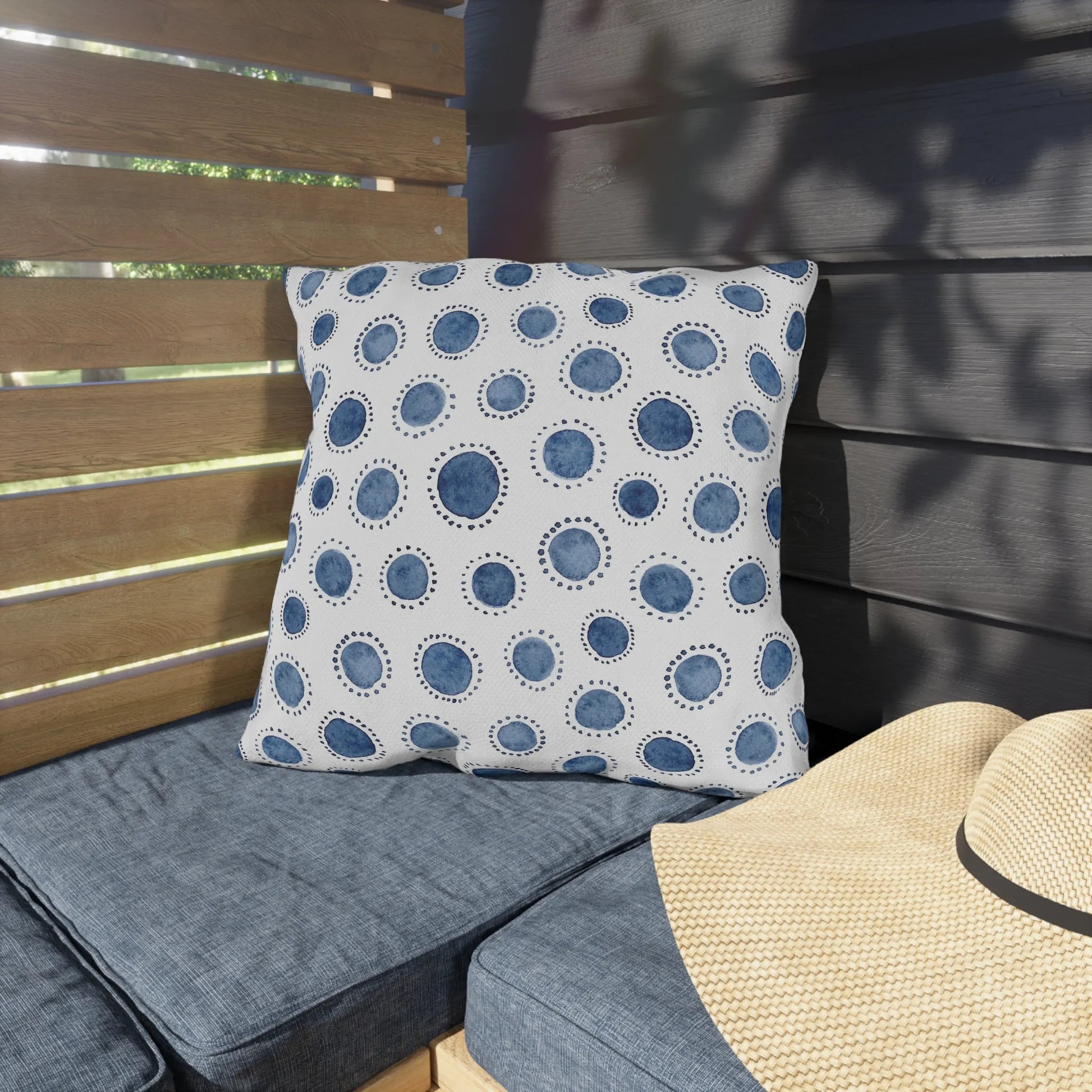 outdoor bench cushion from Blue Water Songs sitting on blue sofa