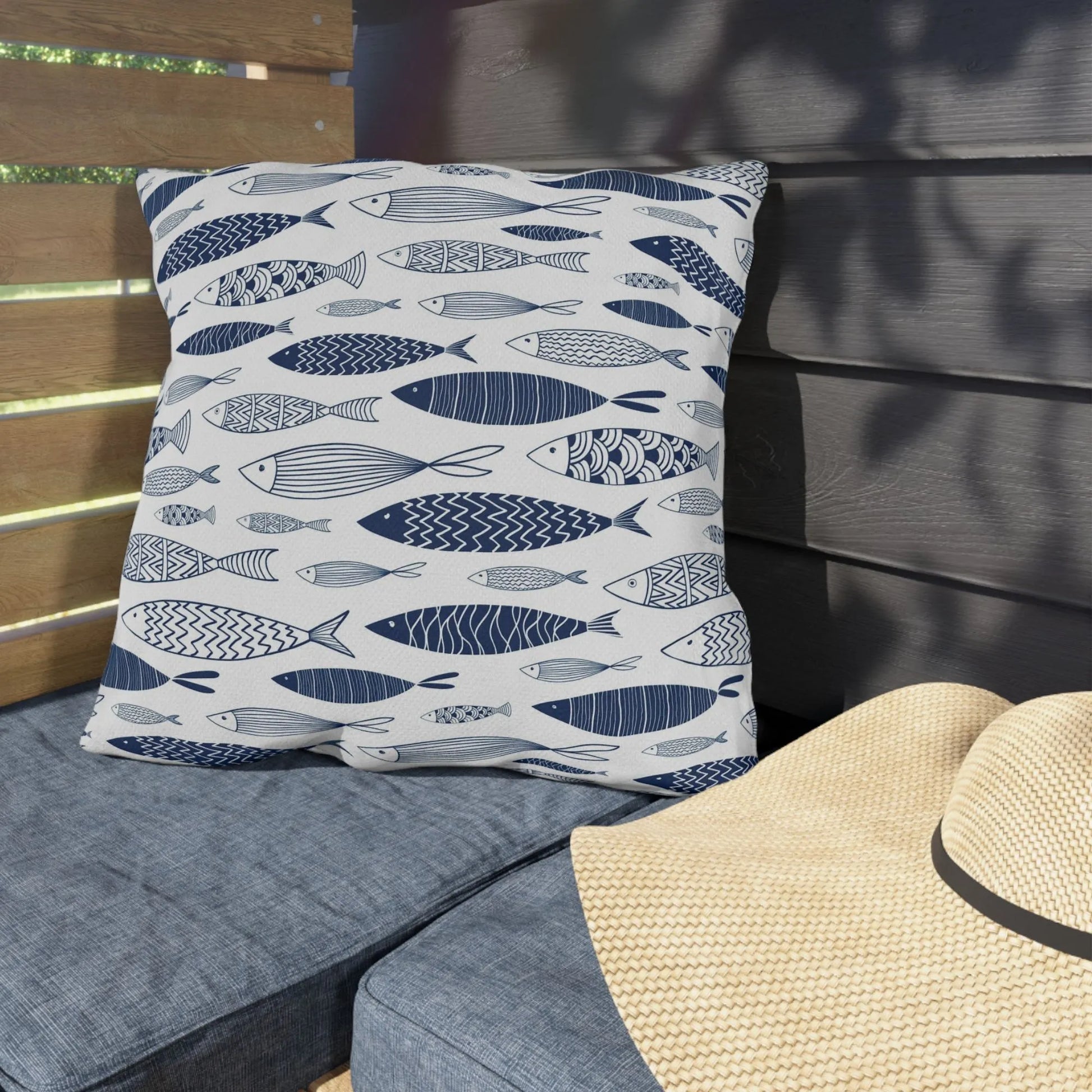 garden porch outdoor cushion from Blue Water Songs next to beach hat