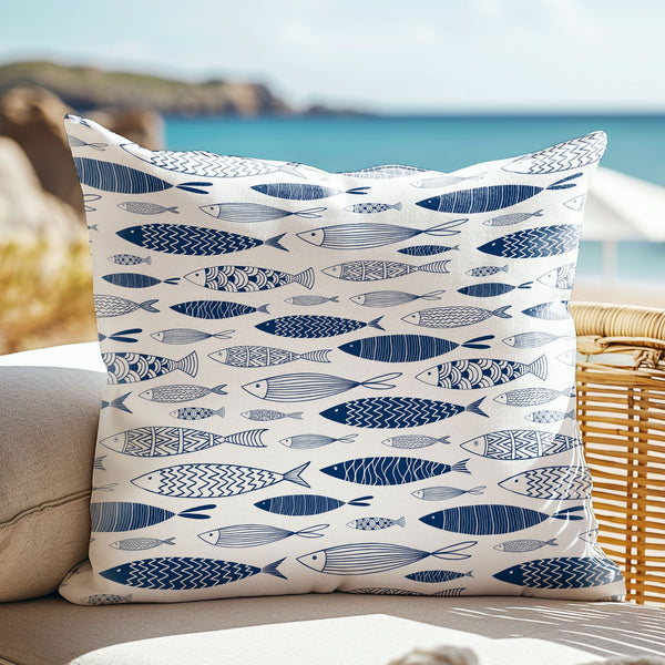 Blue fish throw pillow on beach couch