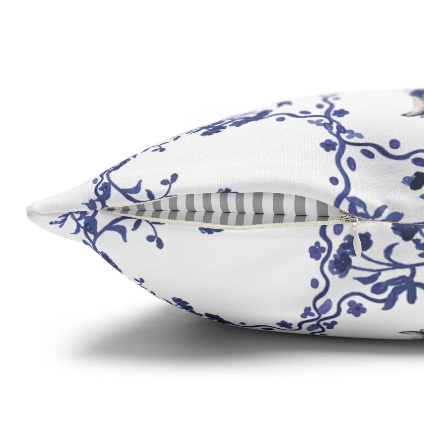 Side view of a white pillow cover with a blue watercolor Chinoiserie rabbit and Easter egg tile pattern, showing the zipper detail.