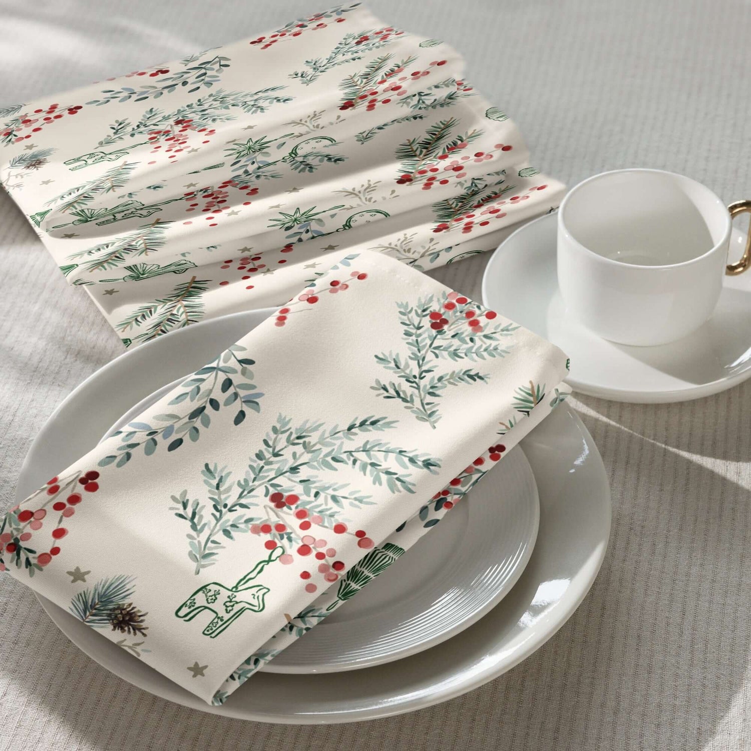 Botanical Christmas Cloth Napkins with pine branches and red berries on a cozy table setting.