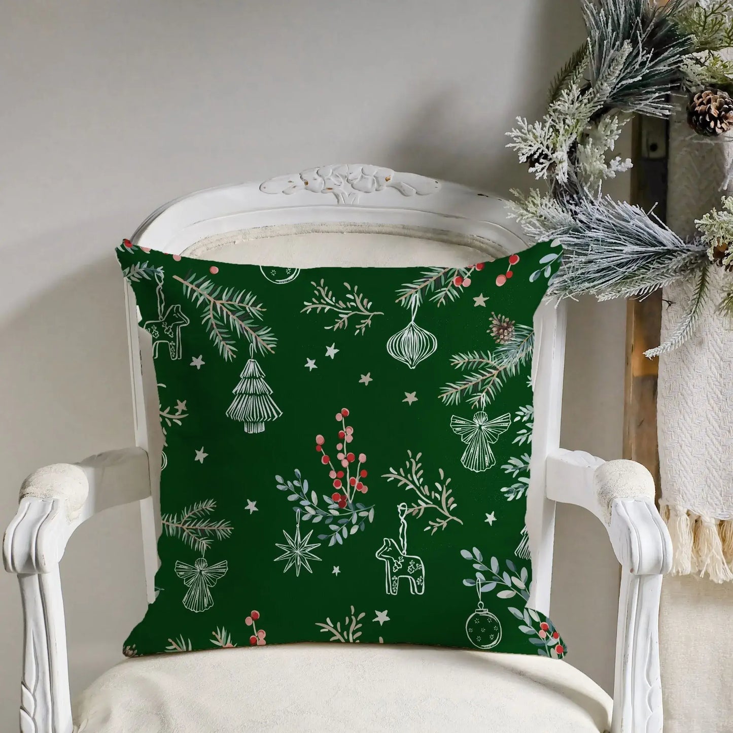 Botanical Christmas pillow cover featuring deep green color with pine branches, red berries, and festive ornaments.