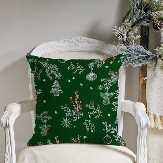 Botanical Christmas pillow cover featuring deep green color with pine branches, red berries, and festive ornaments.