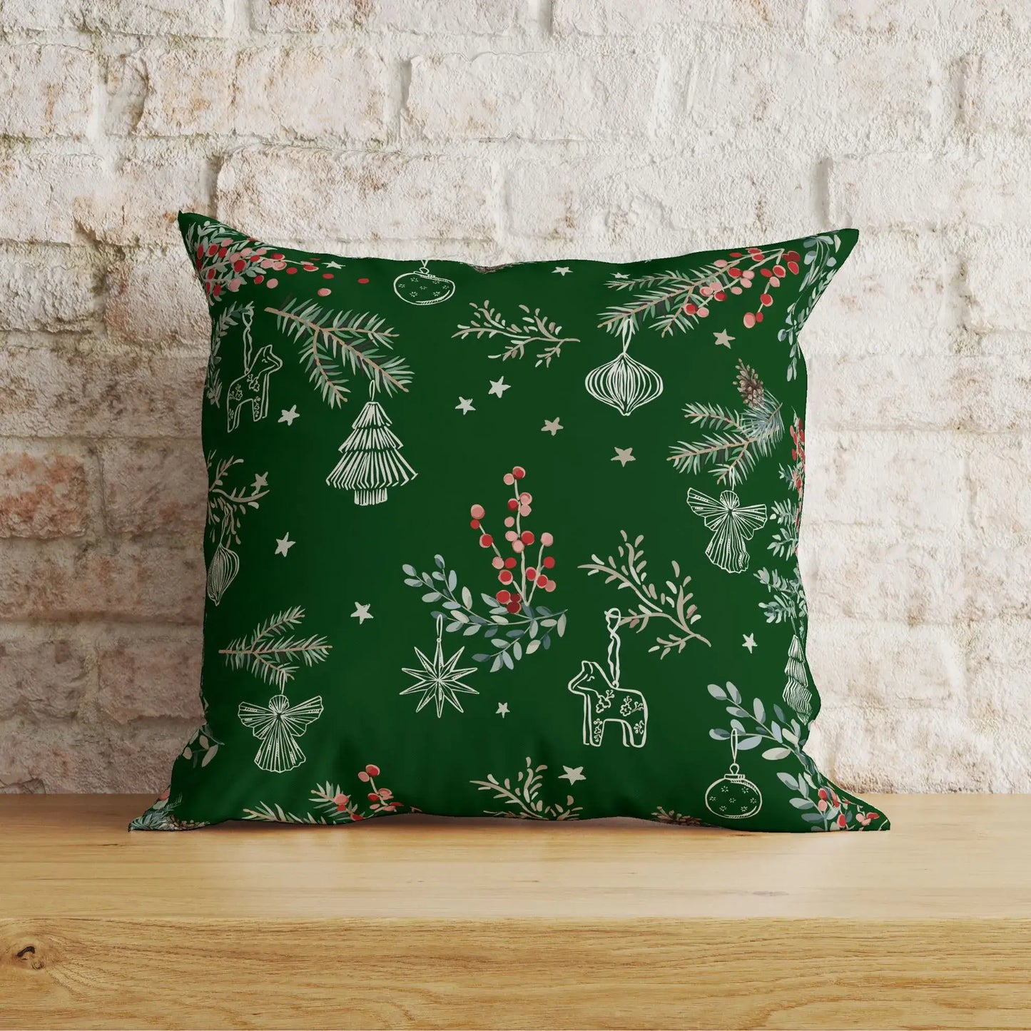 Botanical Christmas pillow cover featuring pine branches, red berries, and festive ornaments on deep green fabric.