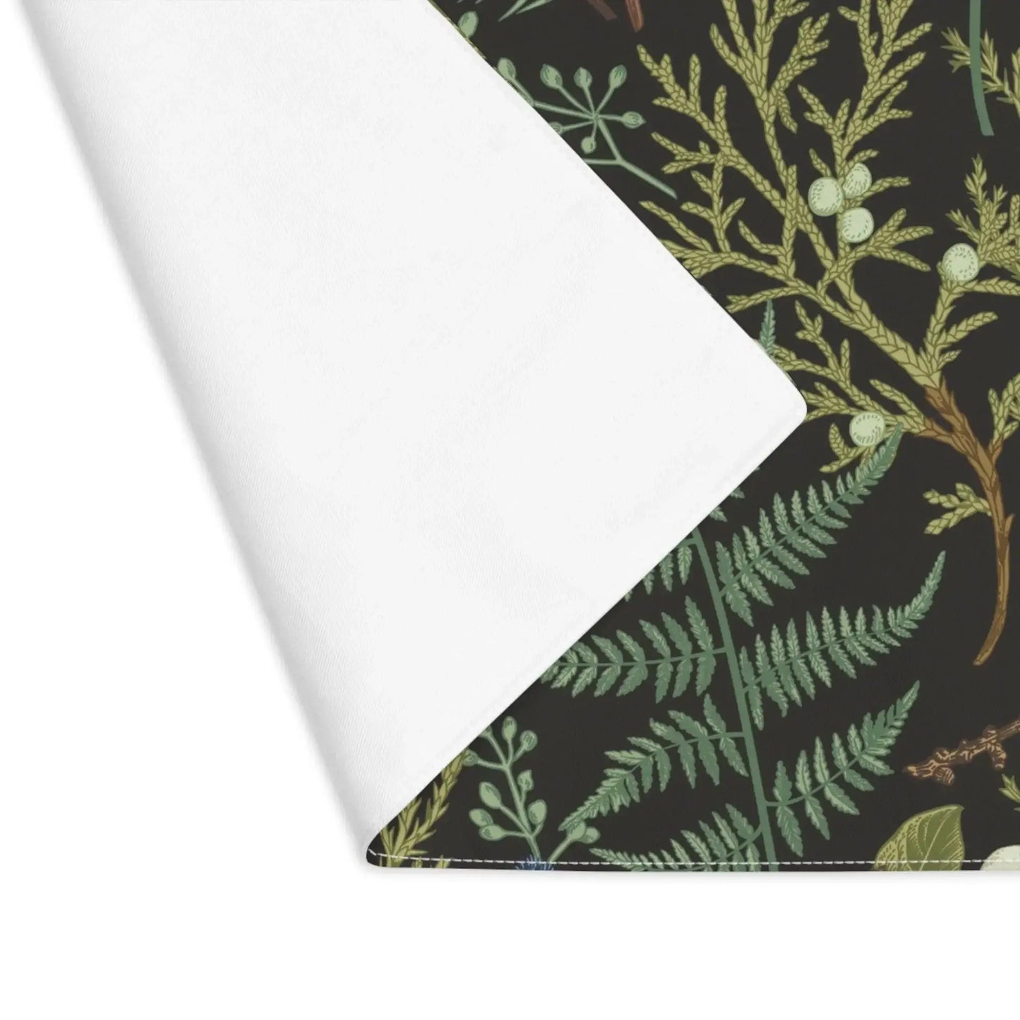 Botanical Christmas placemats featuring soft winter greenery and seasonal florals on a dark background.