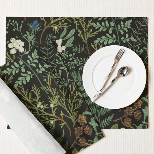 Botanical Christmas placemats featuring soft winter greenery and seasonal florals, styled with neutral dinnerware.