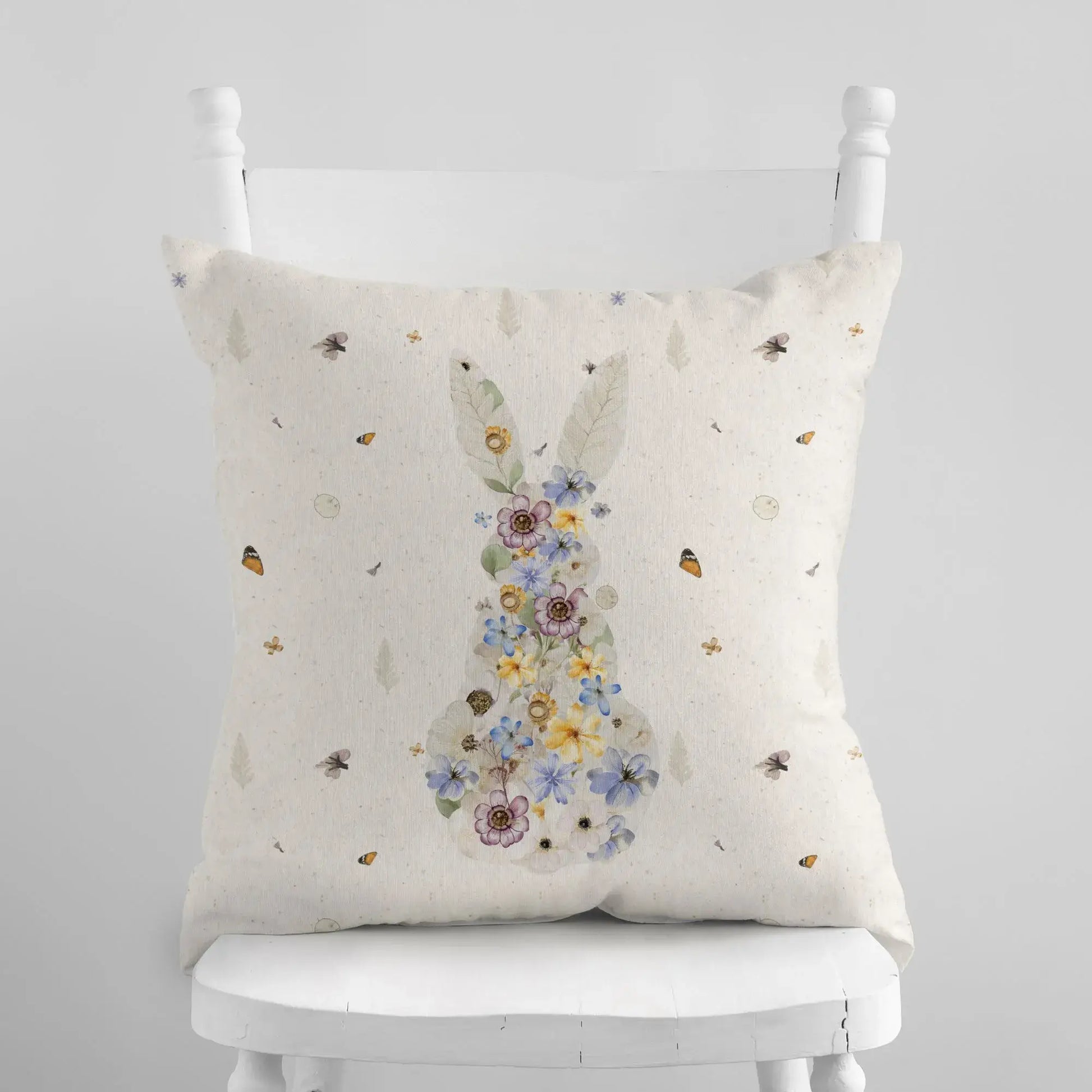 Bunny Pressed Flowers Spring Pillow Cover featuring floral design on a cozy pillow against a neutral background.
