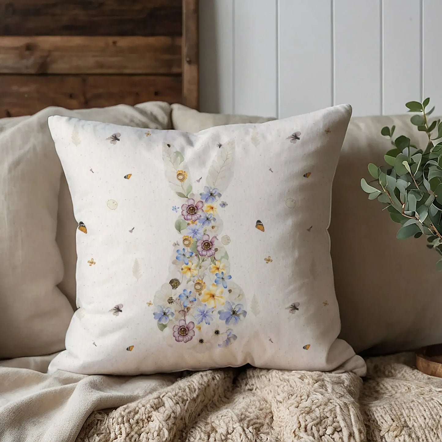 Bunny Pressed Flowers Spring Pillow Cover on a cozy sofa, featuring a delicate bunny silhouette made of watercolor blooms.