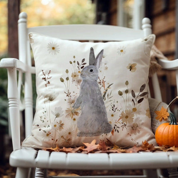 outdoor chair with Watercolor Bunny and Fall Wildflowers PILLOW from Blue Water Songs and pumpkin on it 