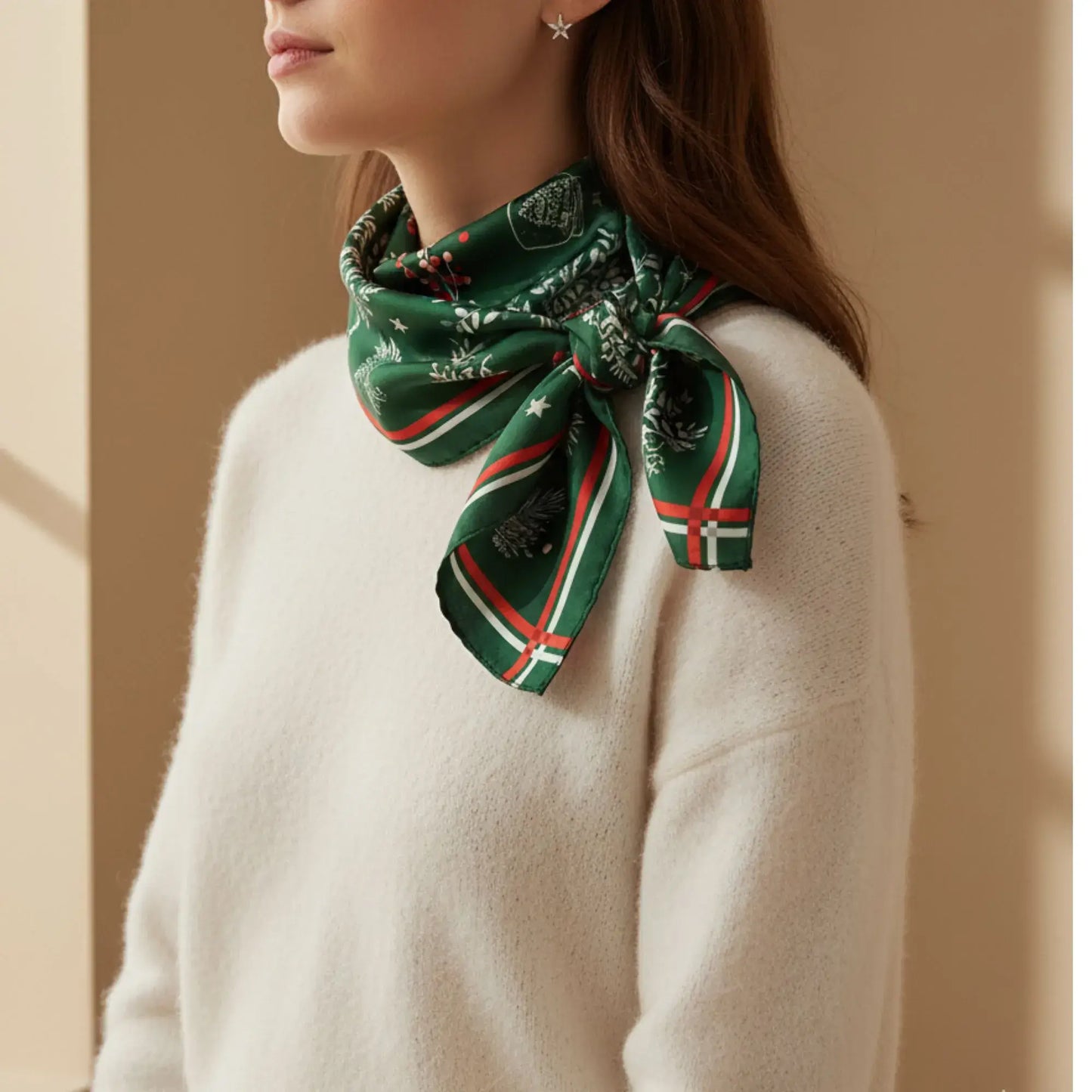 Christmas botanical silk scarf featuring pine and red berry print on a model, styled with a cozy sweater.