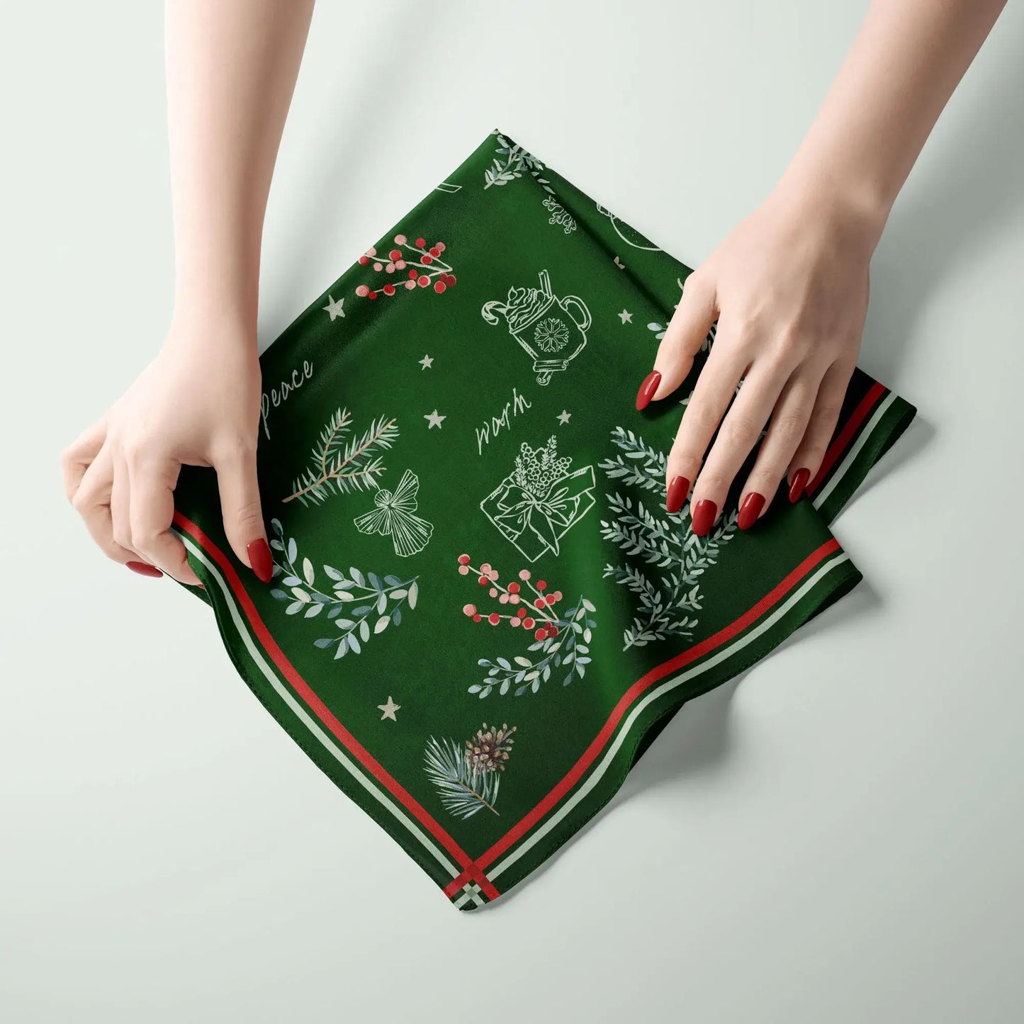 Christmas botanical silk scarf with pine and red berry print, featuring a deep green background and festive border.