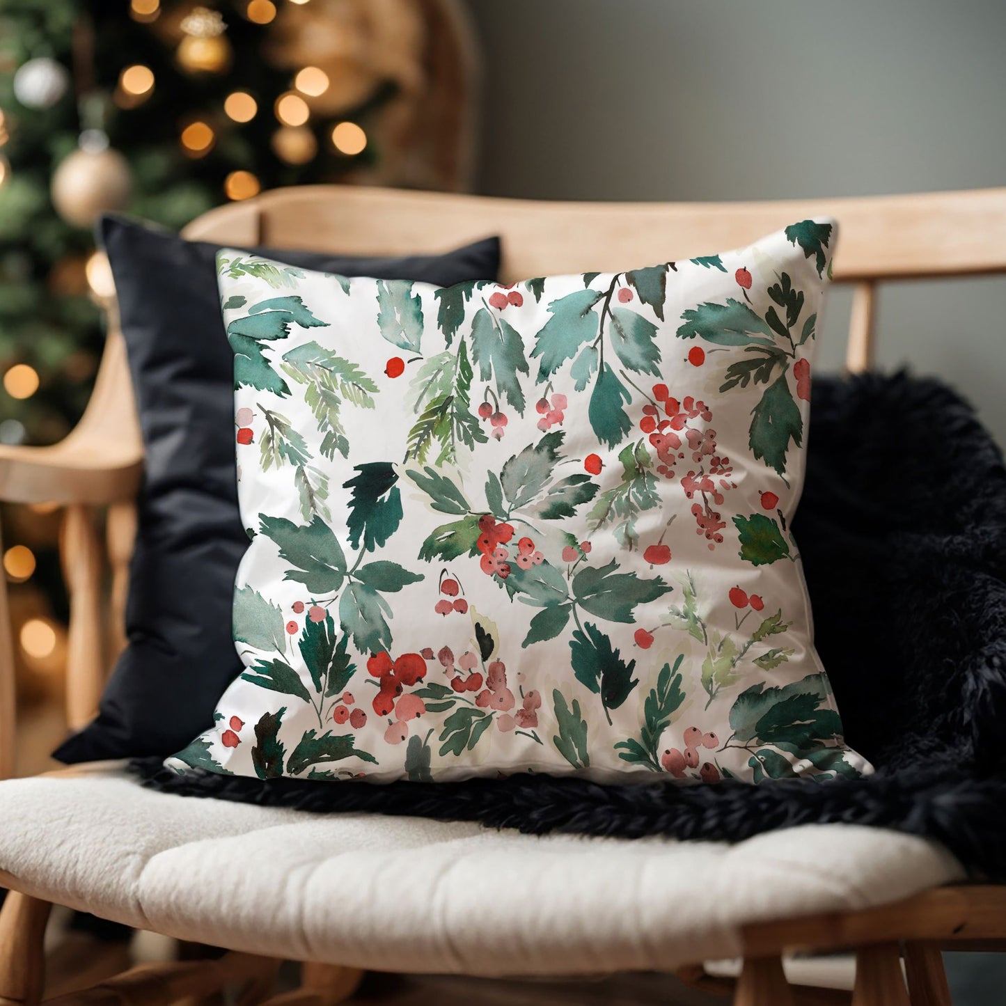 Watercolor Christmas pillow with red berries and greenery on wooden bench – cozy holiday decor with tree in background