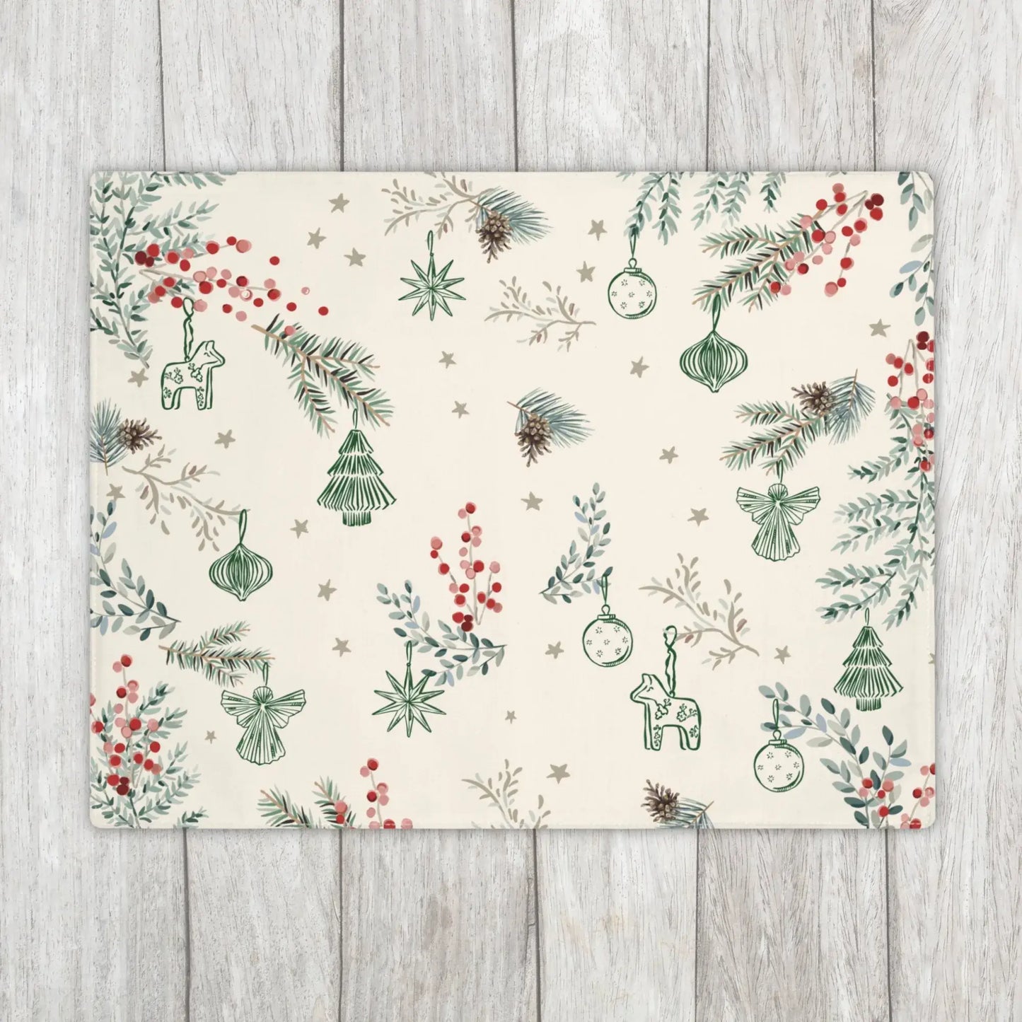 Botanical Christmas Placemat in cream with pine and berry print on rustic wooden background.