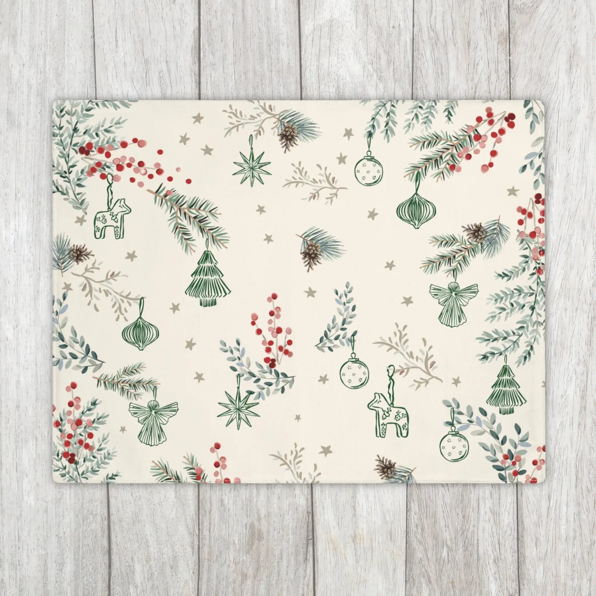 Botanical Christmas Placemat in cream with pine and berry print on rustic wooden background.