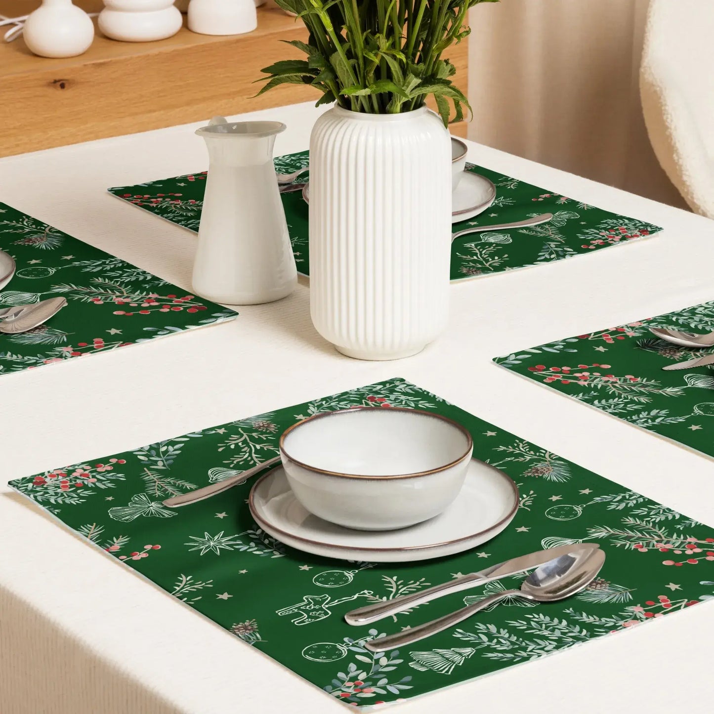 Festive dining table with green Botanical Christmas Placemats featuring pine and berry print.