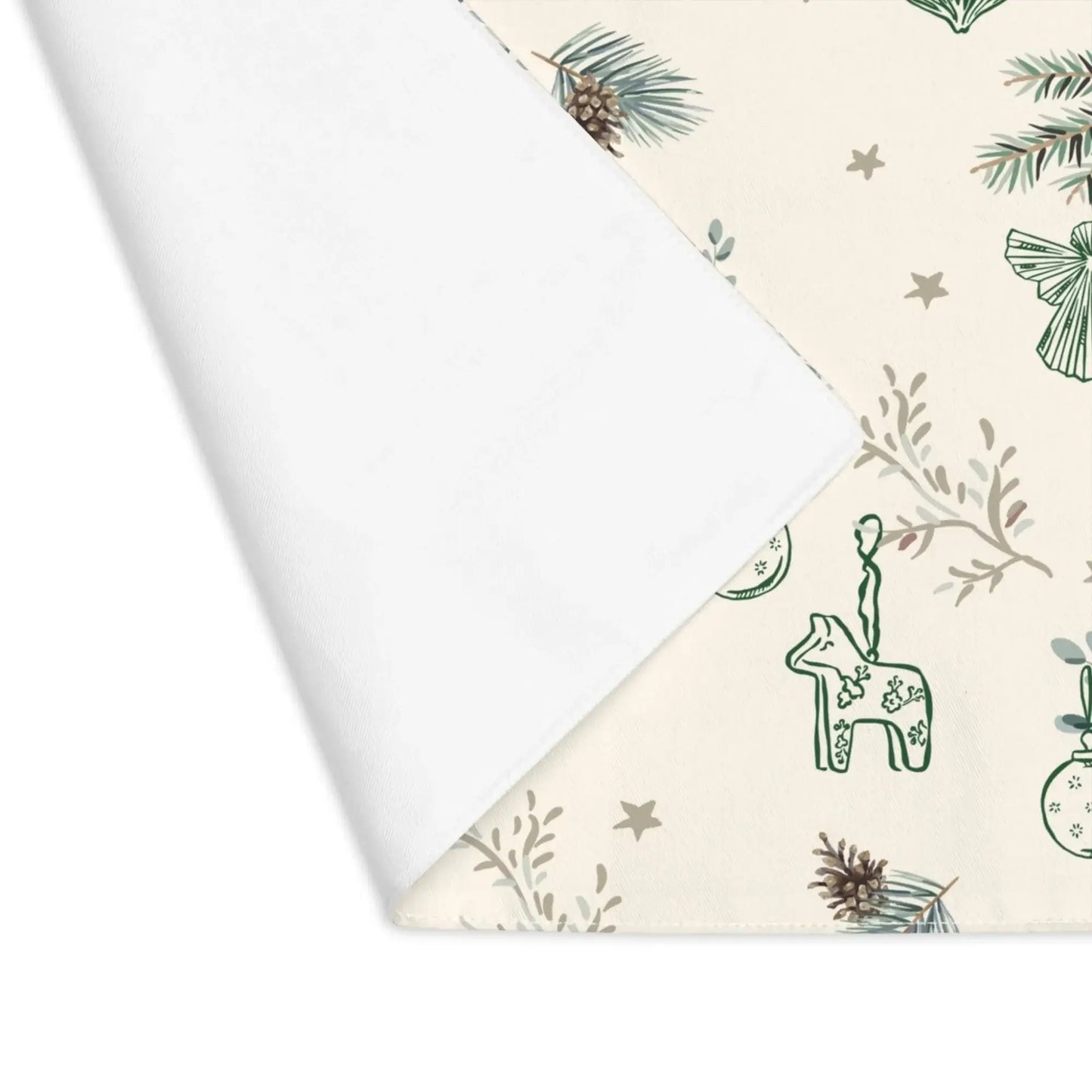 Corner view of cream Botanical Christmas Placemat with pine and reindeer print on white backing