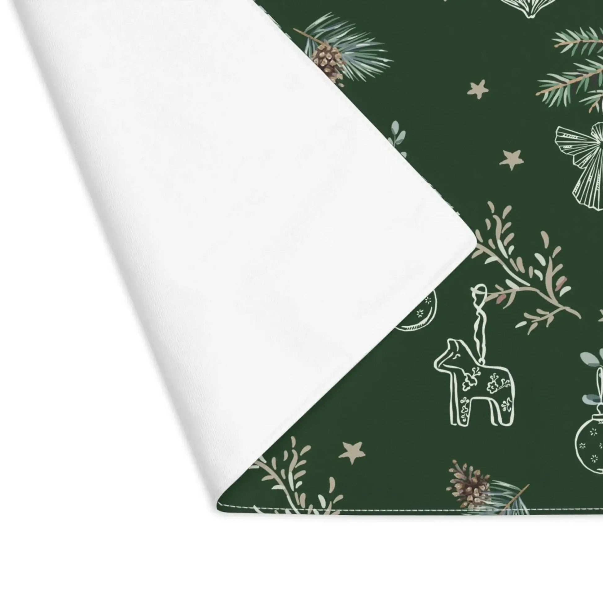 Corner view of green Botanical Christmas Placemat with pine and reindeer print on green backing