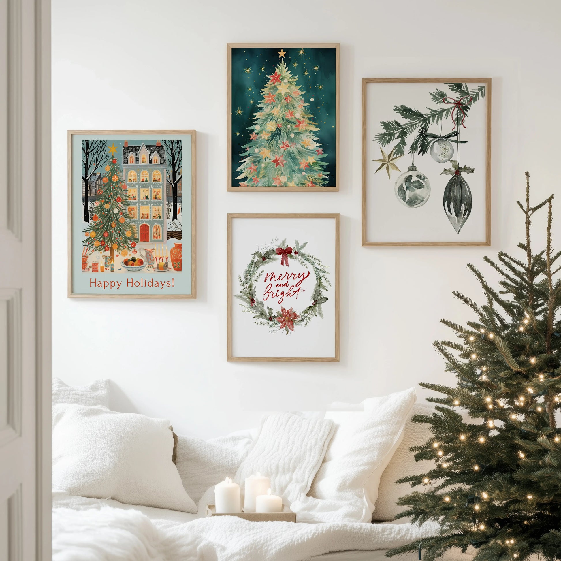 Christmas Prints Set of 4 displayed on a wall above a cozy sofa with a Christmas tree.
