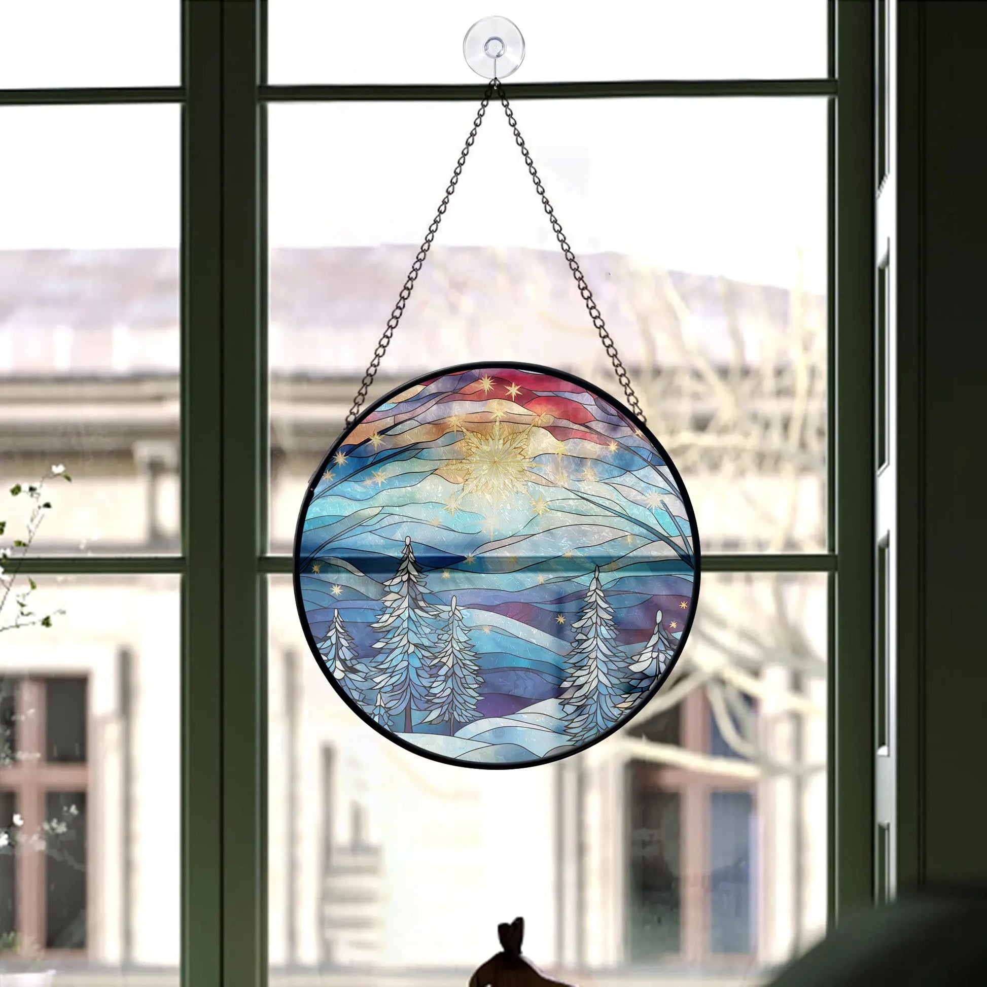 window with Blue Christmas Tree Round Stained Glass Ornament hanging on it