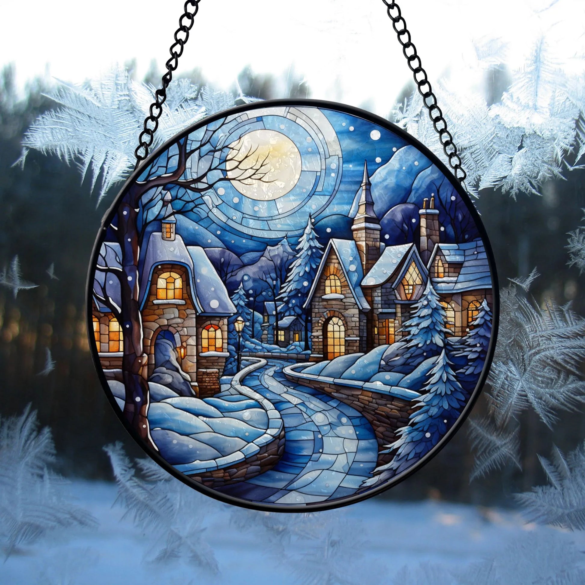 Winter Village Christmas Round Stained Glass Ornament hanging on winter window