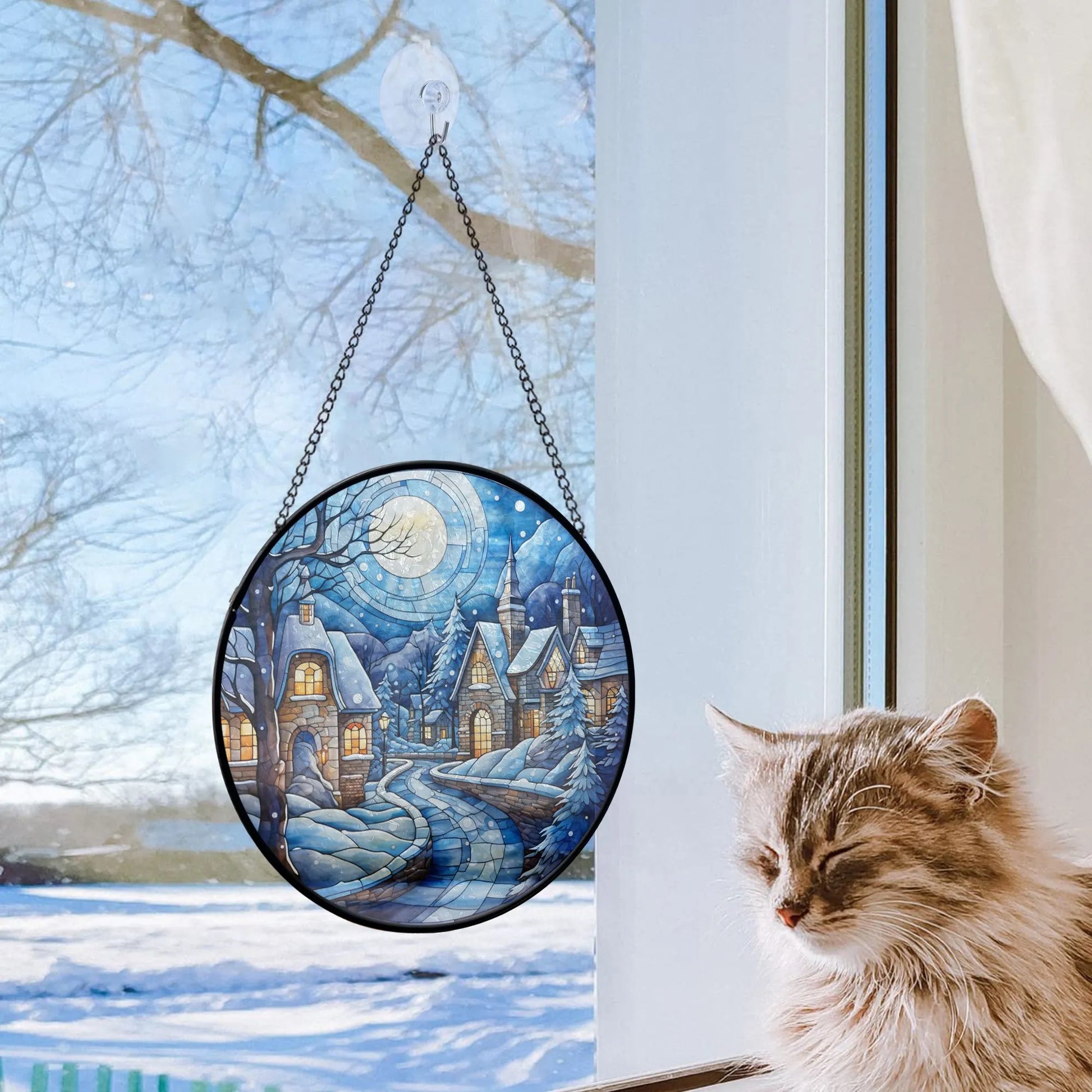 lovely cat next to glass ornament hanging on window