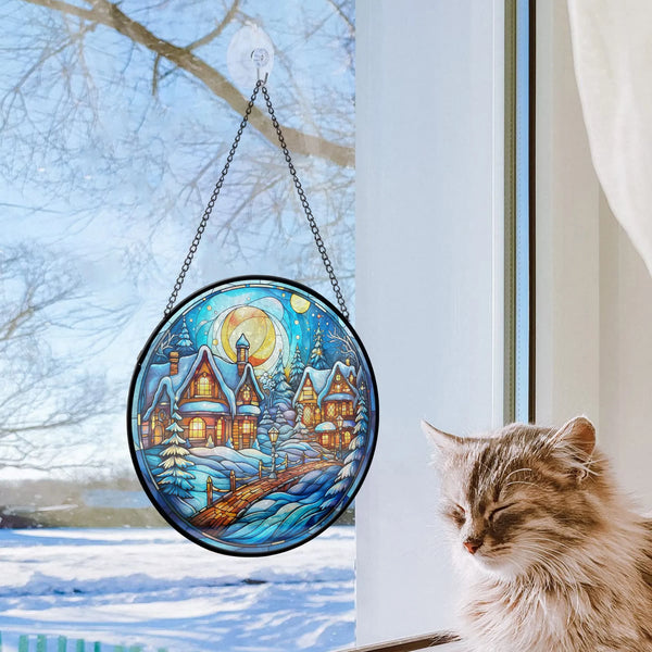 Cat sitting next to christmas window with decorative hanging ornament on it