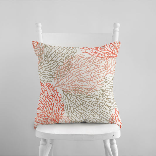 coral throw pillow on white chair