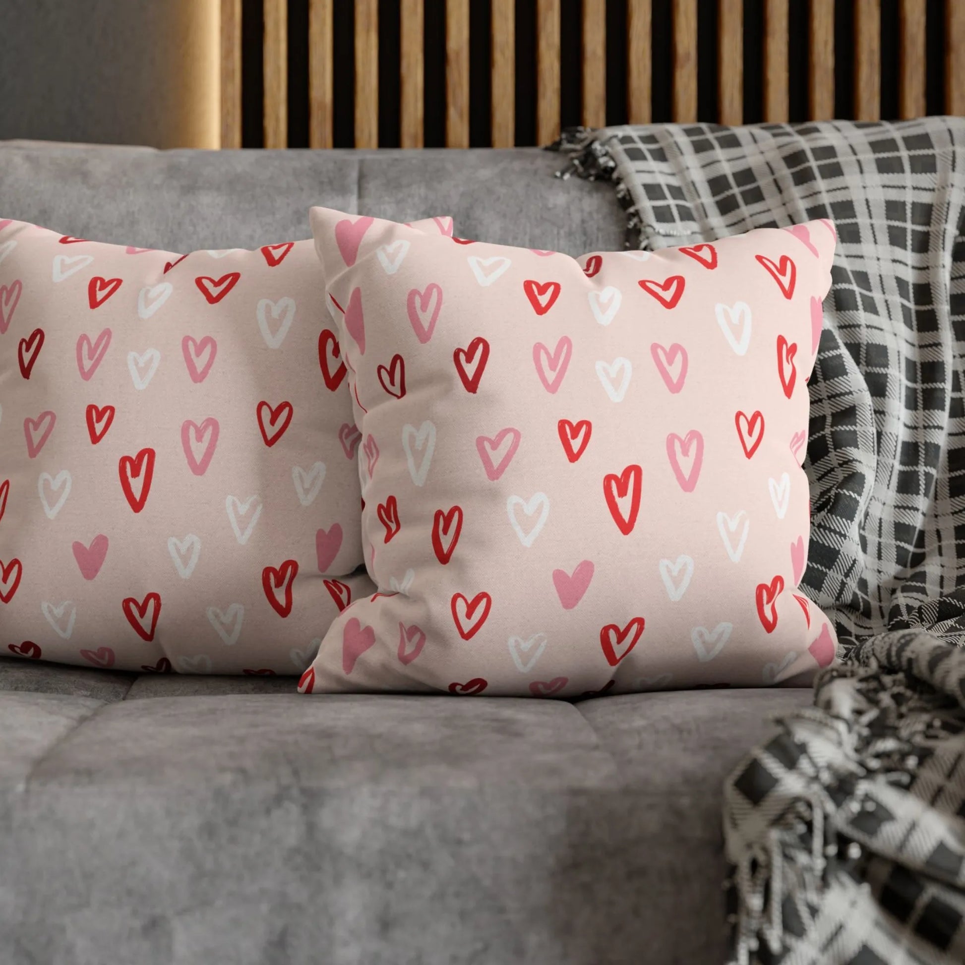 Cute Hand-Drawn Hearts Valentine Pillow on a gray sofa with a patterned throw, Blue Water Songs brand.