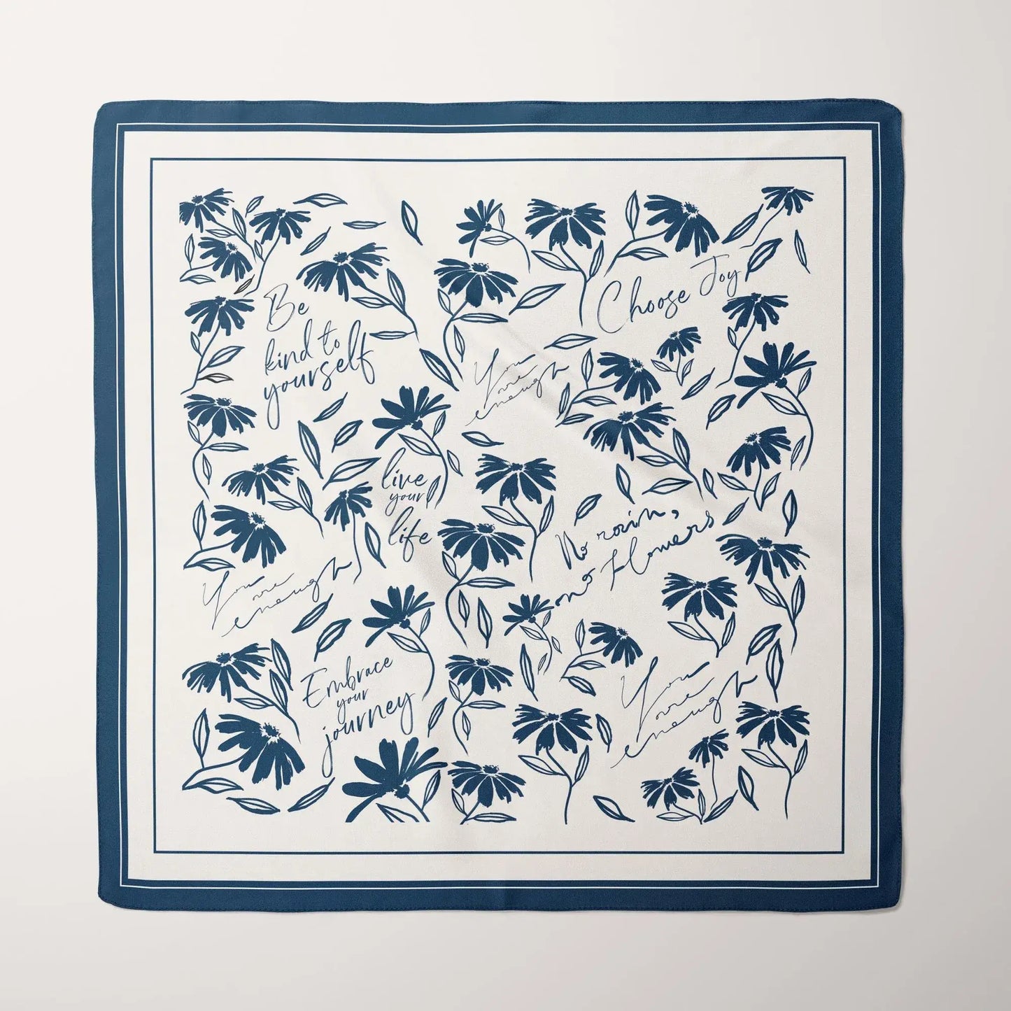 Blue daisy wildflowers silk scarf laid flat showing full botanical floral print with navy border