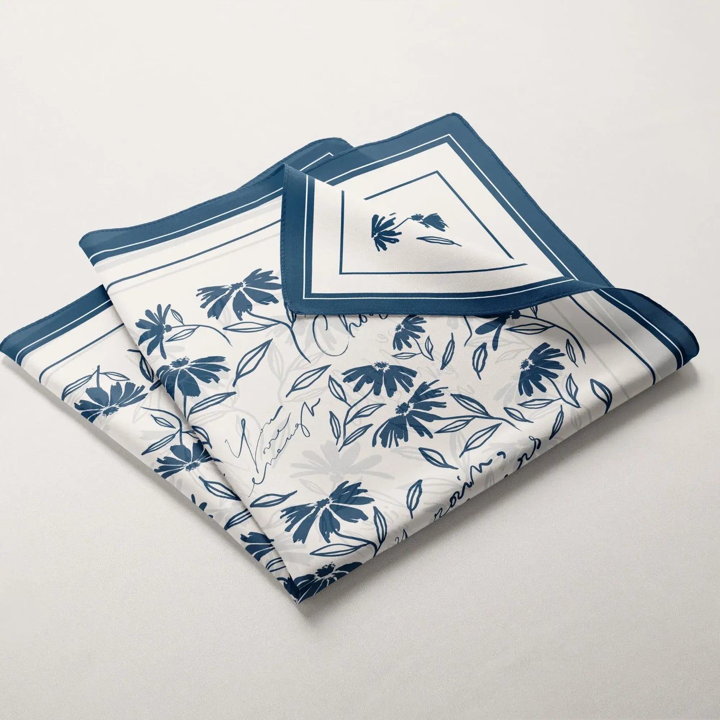 Folded daisy wildflowers silk scarf in blue palette showing minimal botanical floral pattern and border
