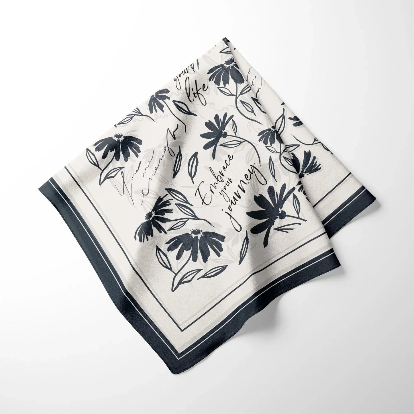 Minimal daisy wildflowers silk scarf neatly folded showing floral pattern and soft fabric texture