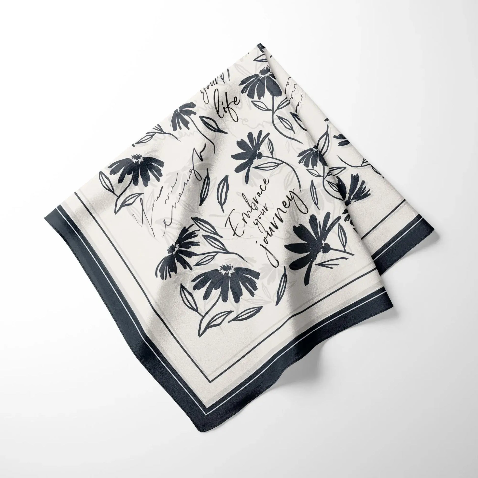 Minimal daisy wildflowers silk scarf neatly folded showing floral pattern and soft fabric texture