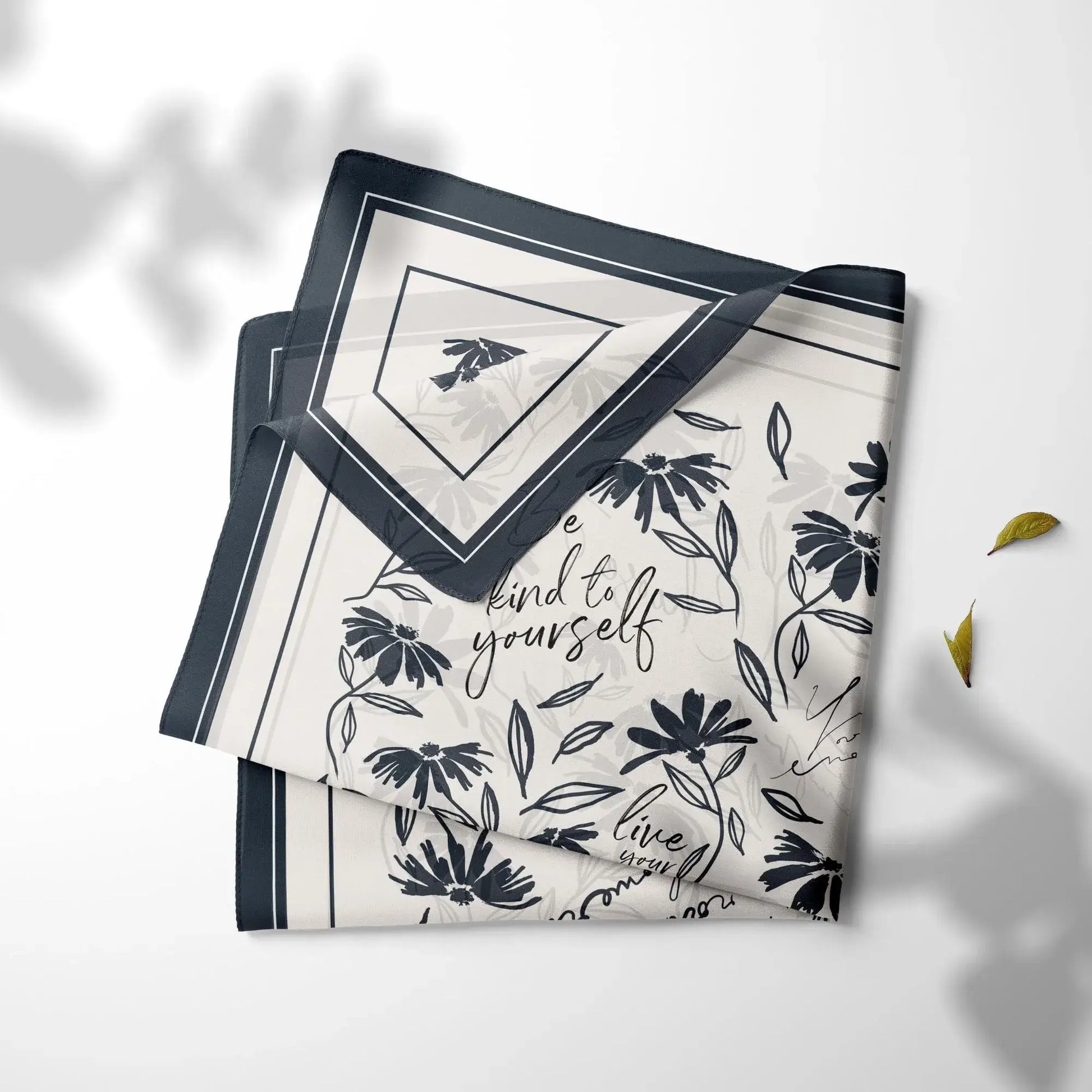 Folded daisy wildflowers silk scarf with minimal black floral illustrations and navy border