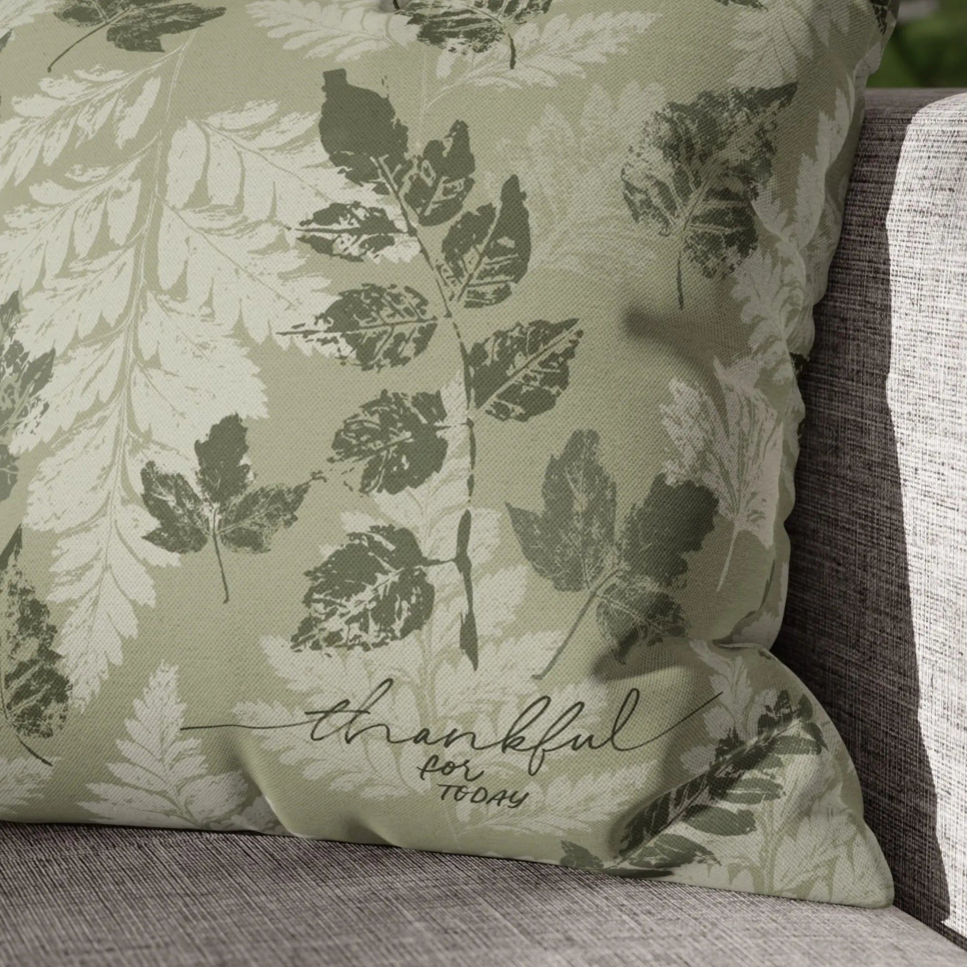 close look of white chair with Autumn Leaves Green PILLOW & COVER from Blue Water Songs on it