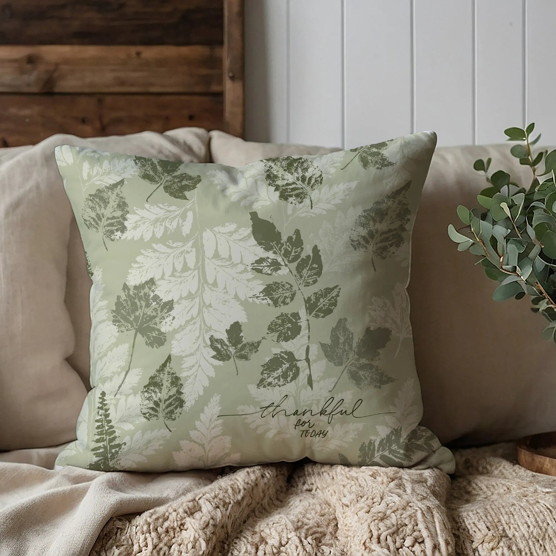 brown sofa with Autumn Leaves Green PILLOW from Blue Water Songs on it