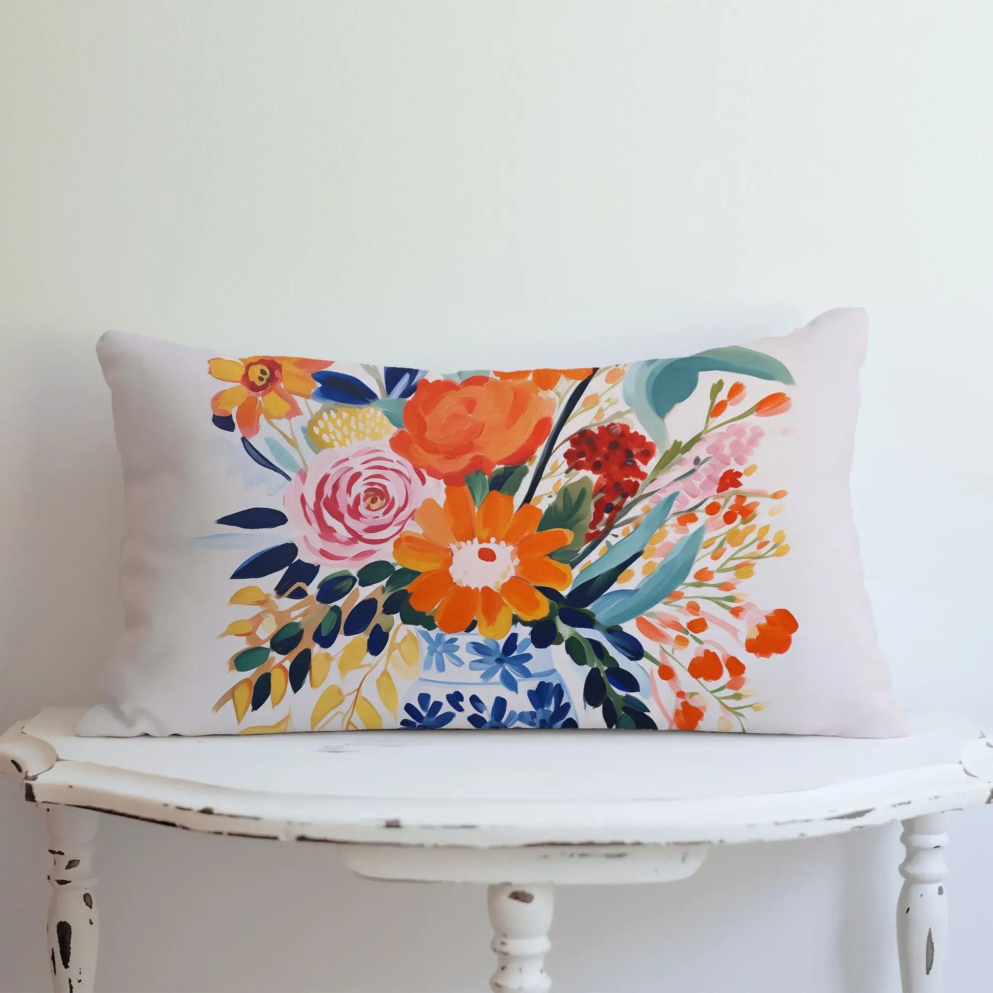 Fall floral pillow cover featuring autumn harvest blooms in vibrant colors on a decorative lumbar pillow