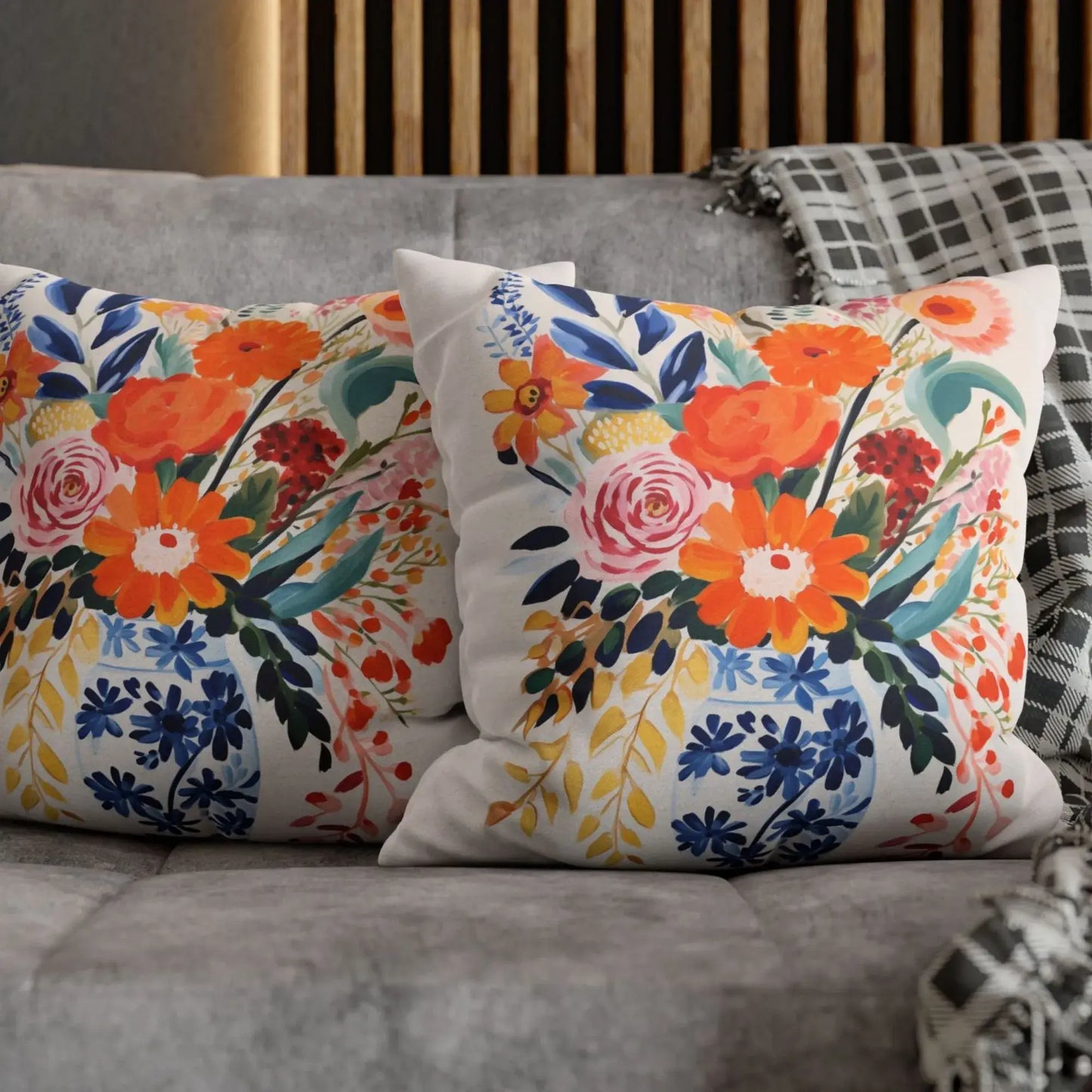 Fall floral pillow cover with vibrant autumn blooms in orange, yellow, and pink on a cozy sofa.