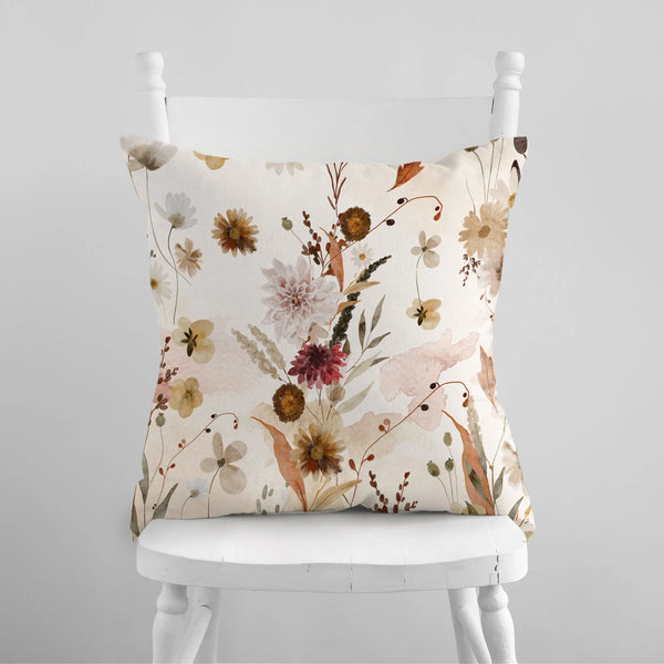 white chair with Watercolor Floral Autumn PILLOW from Blue Water Songs on it